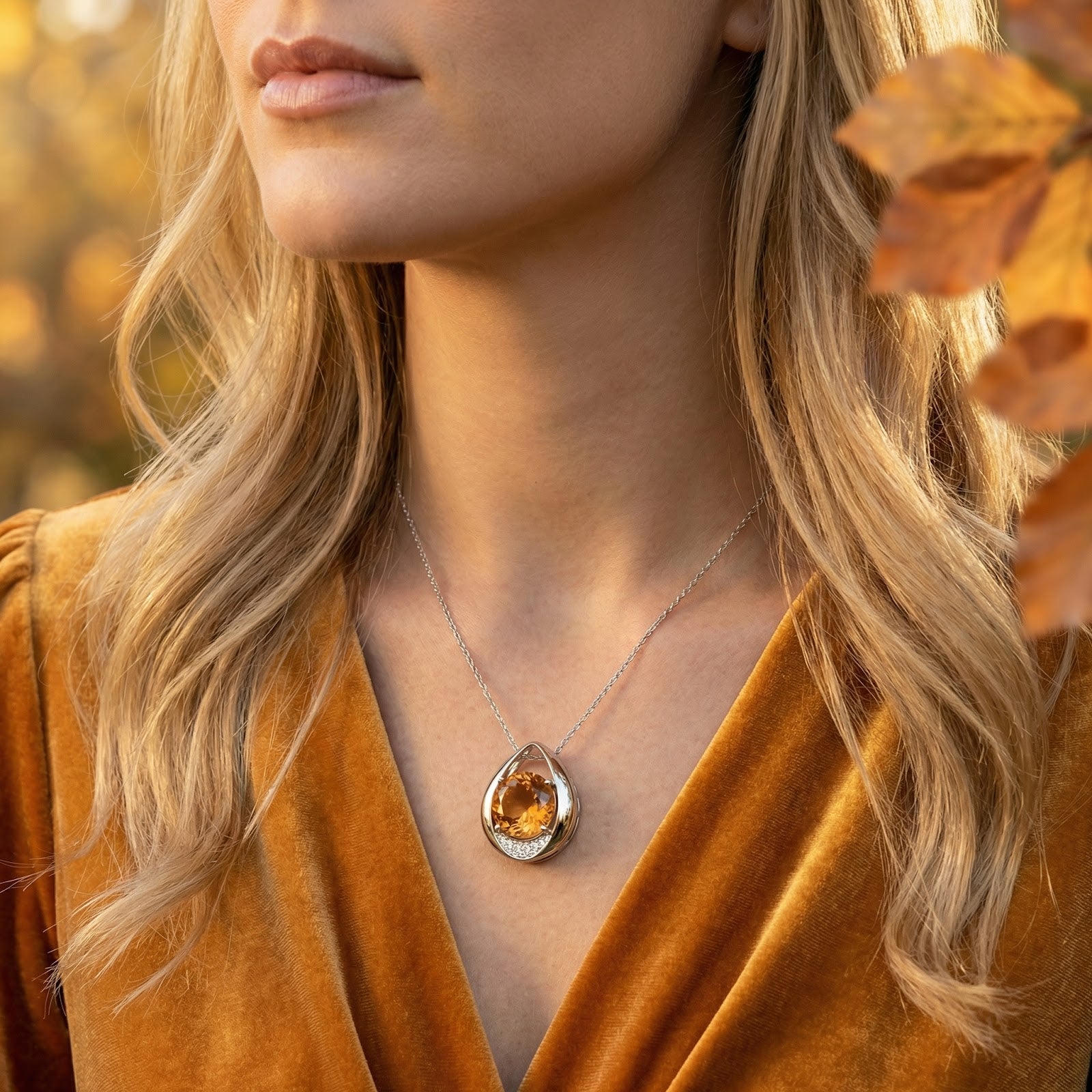 Model wearing the Aurellia teardrop necklace in S925 sterling silver with a honeyed simulated topaz birthstone.