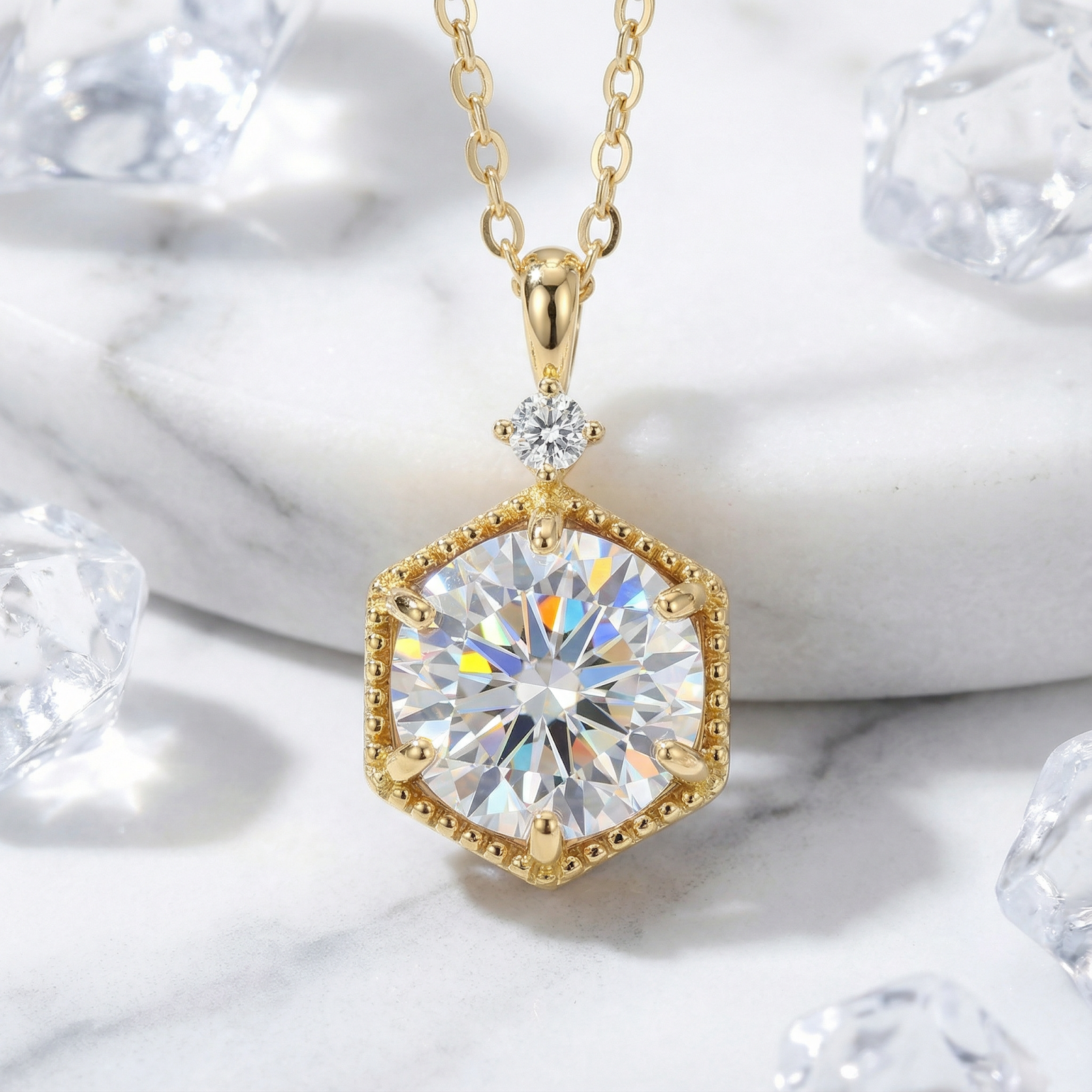 Hexa Radiant 18K gold vermeil necklace with a round simulated diamond in a hexagonal bezel on marble.