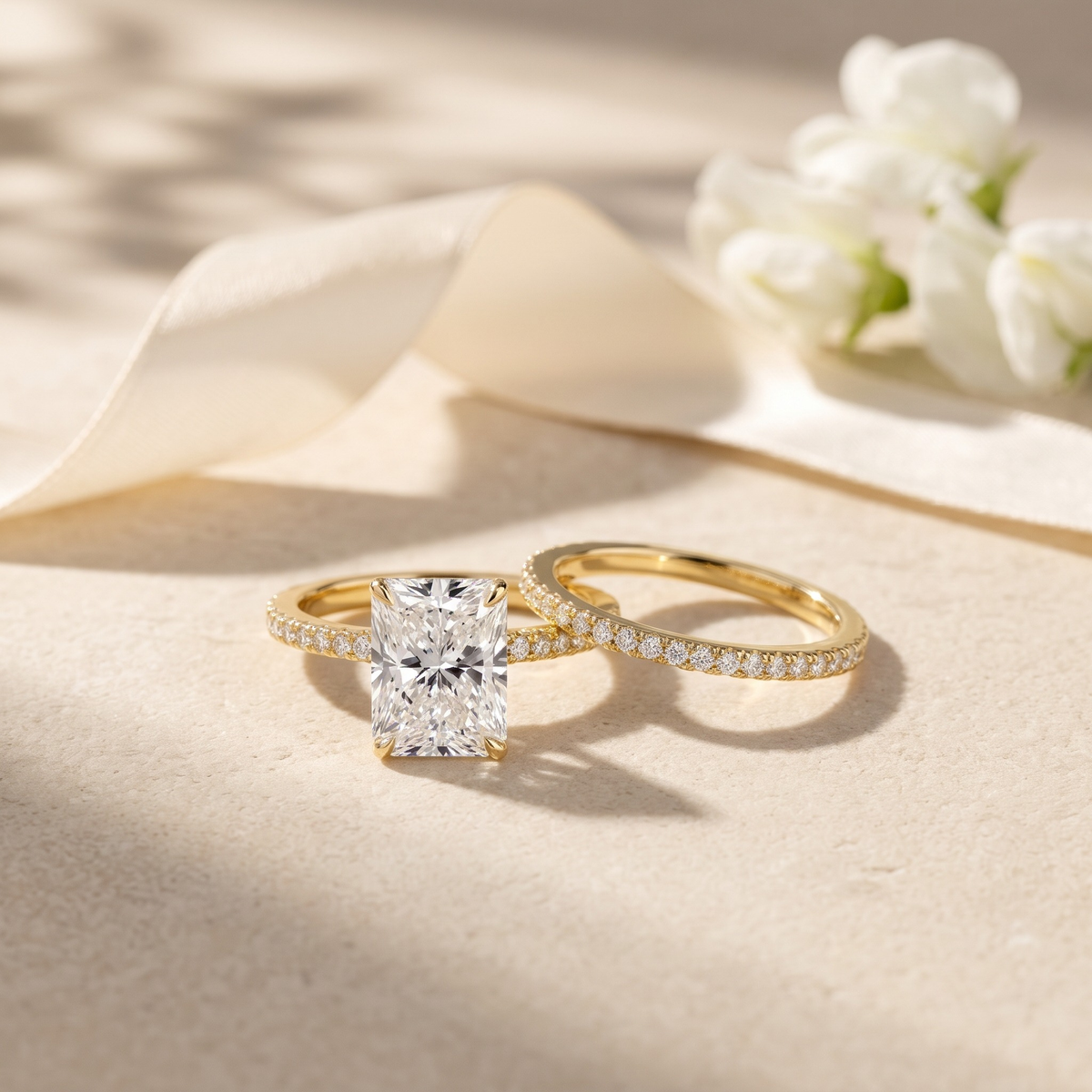 Two-piece radiant-cut moissanite ring set in yellow gold, front product view.