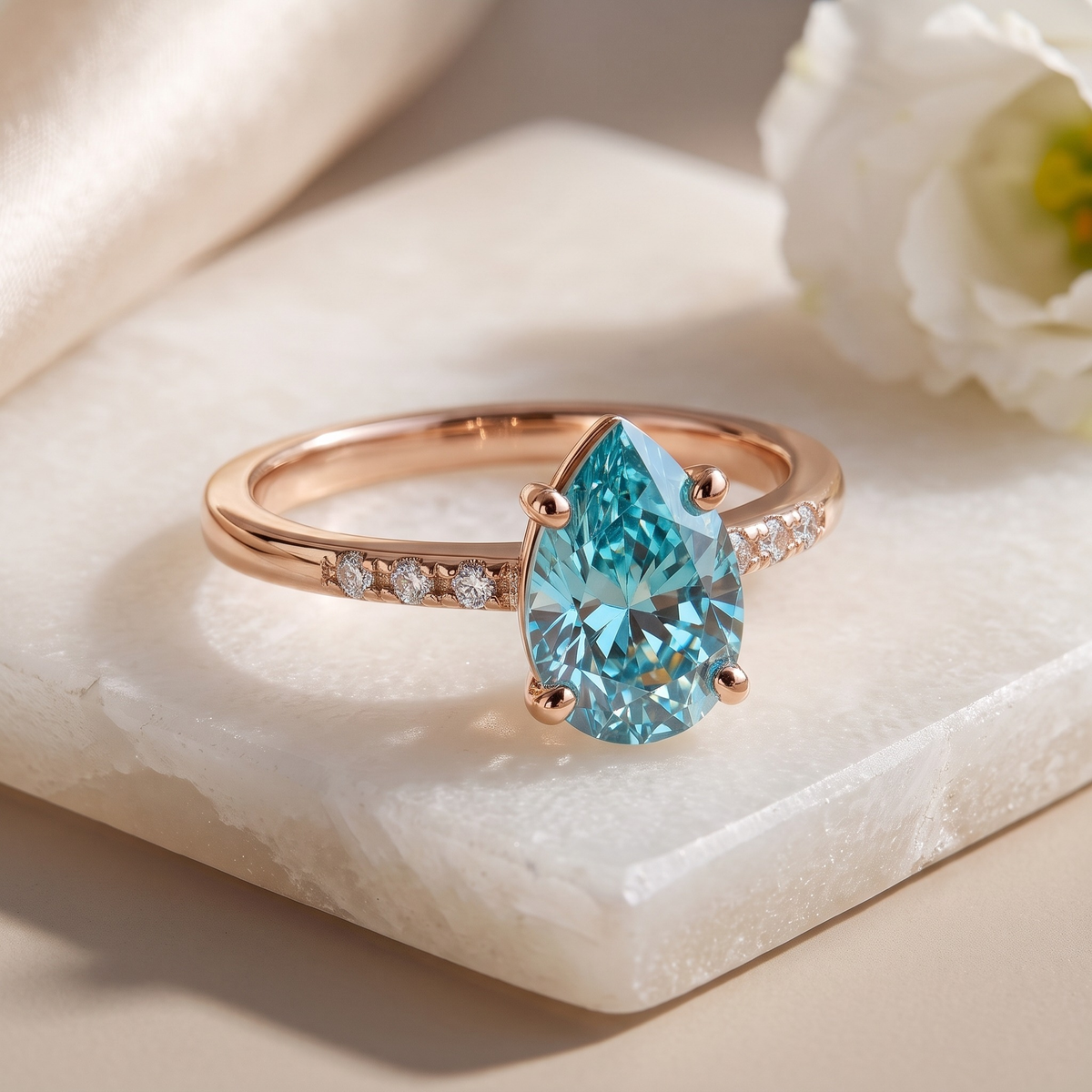 Marissa aqua-blue pear moissanite ring in rose gold, angled close-up