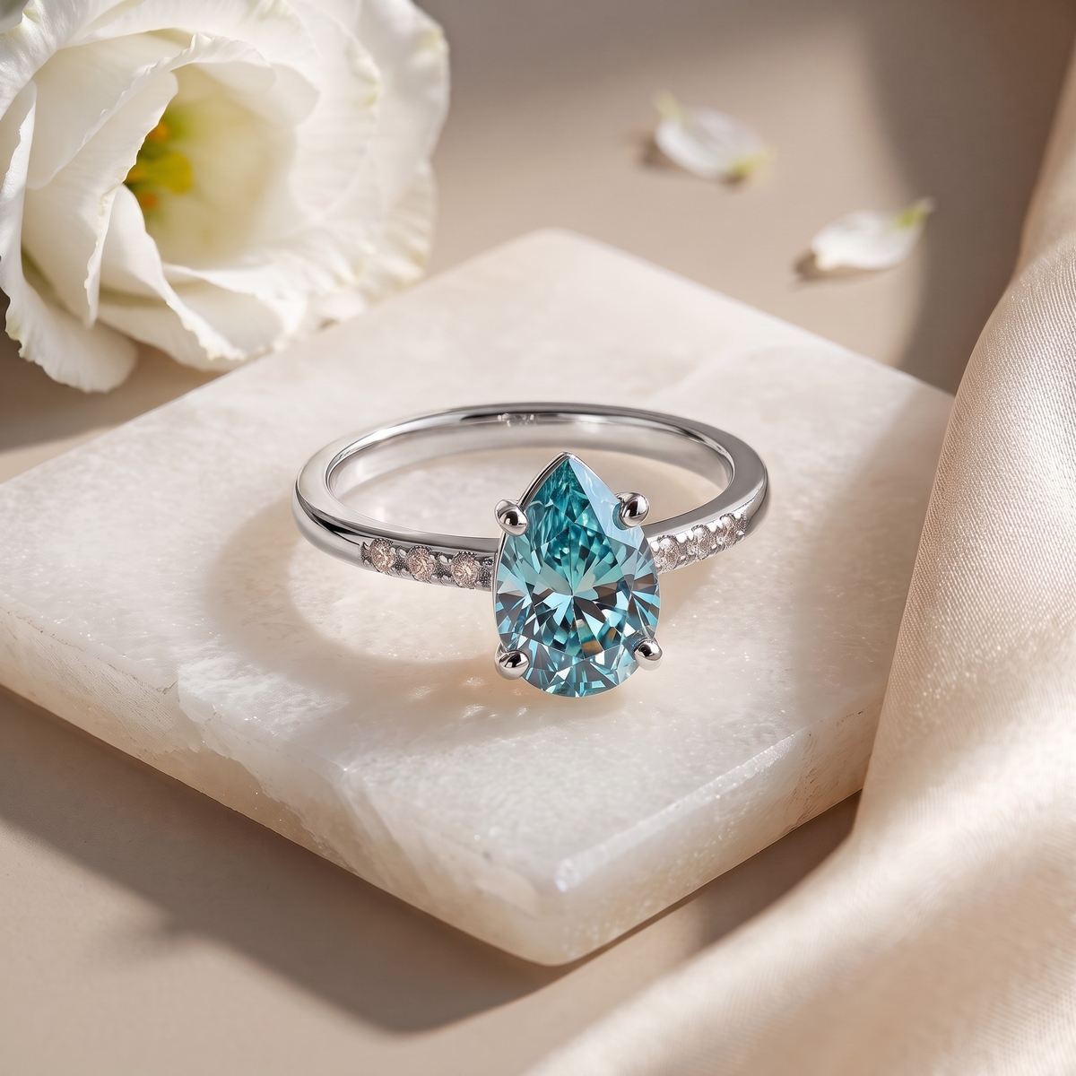 Marissa aqua-blue pear moissanite ring in silver, isolated front view
