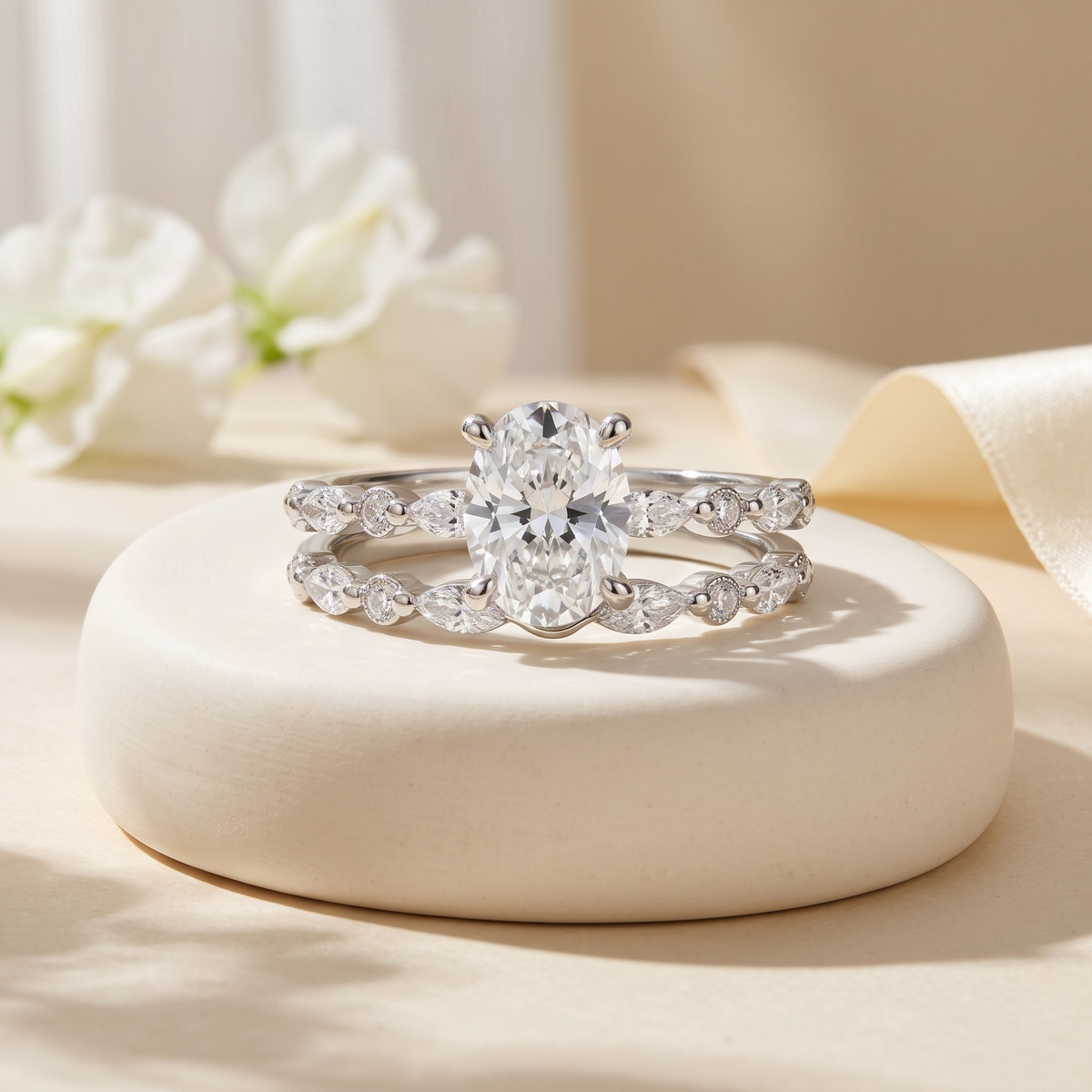 Oval moissanite two-piece ring set in silver, isolated front view
