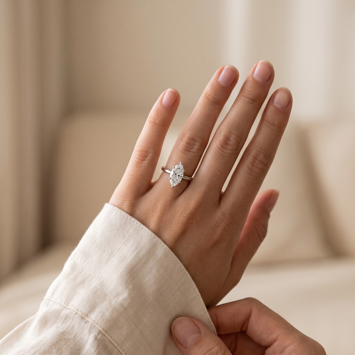 Silver marquise moissanite solitaire worn by a model, cuff detail