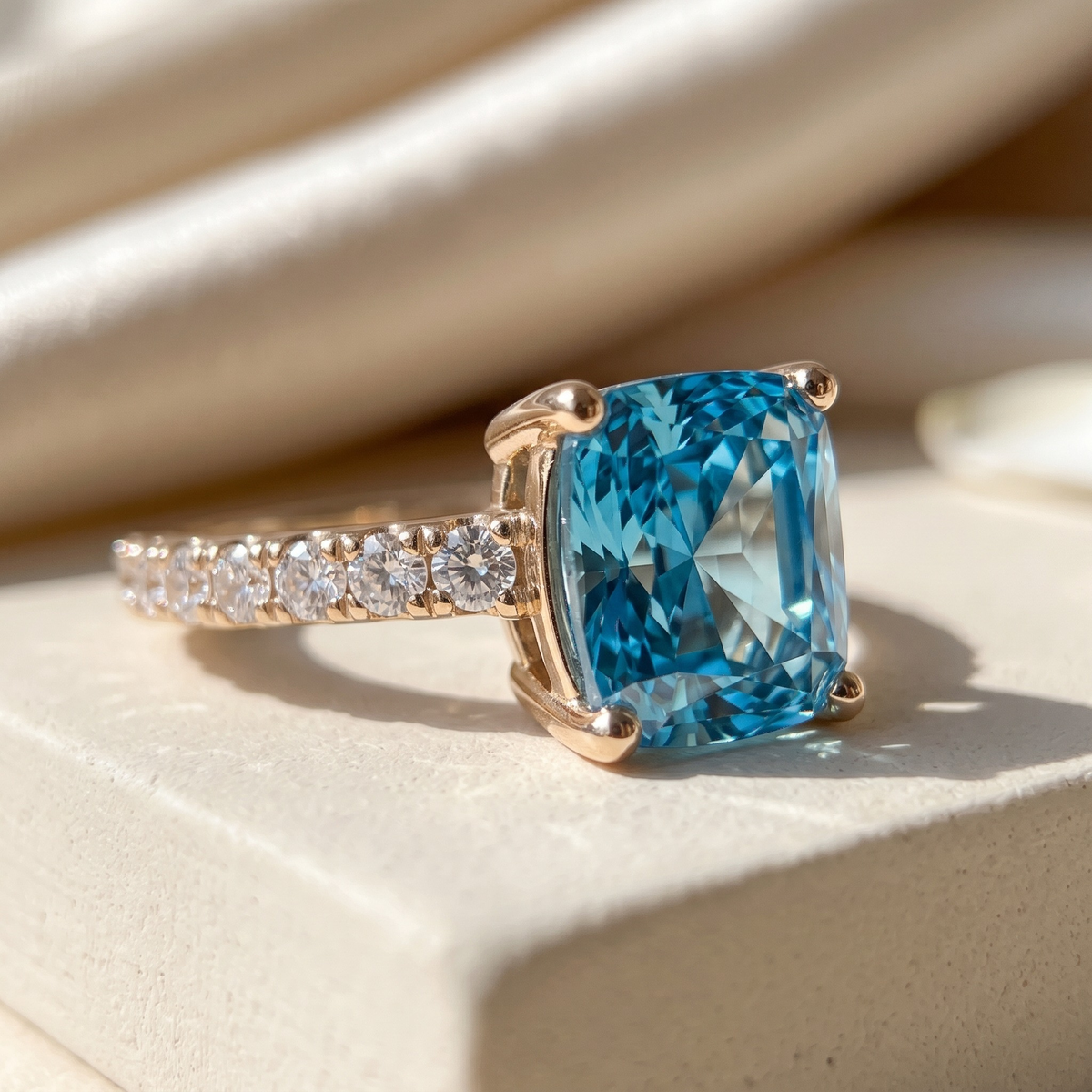 The Juliana Hope blue cushion moissanite ring in yellow gold, macro close-up