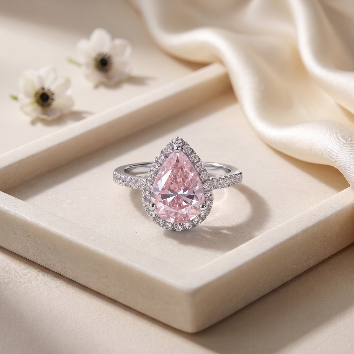 The Sabira pink pear moissanite halo ring in silver, isolated product view