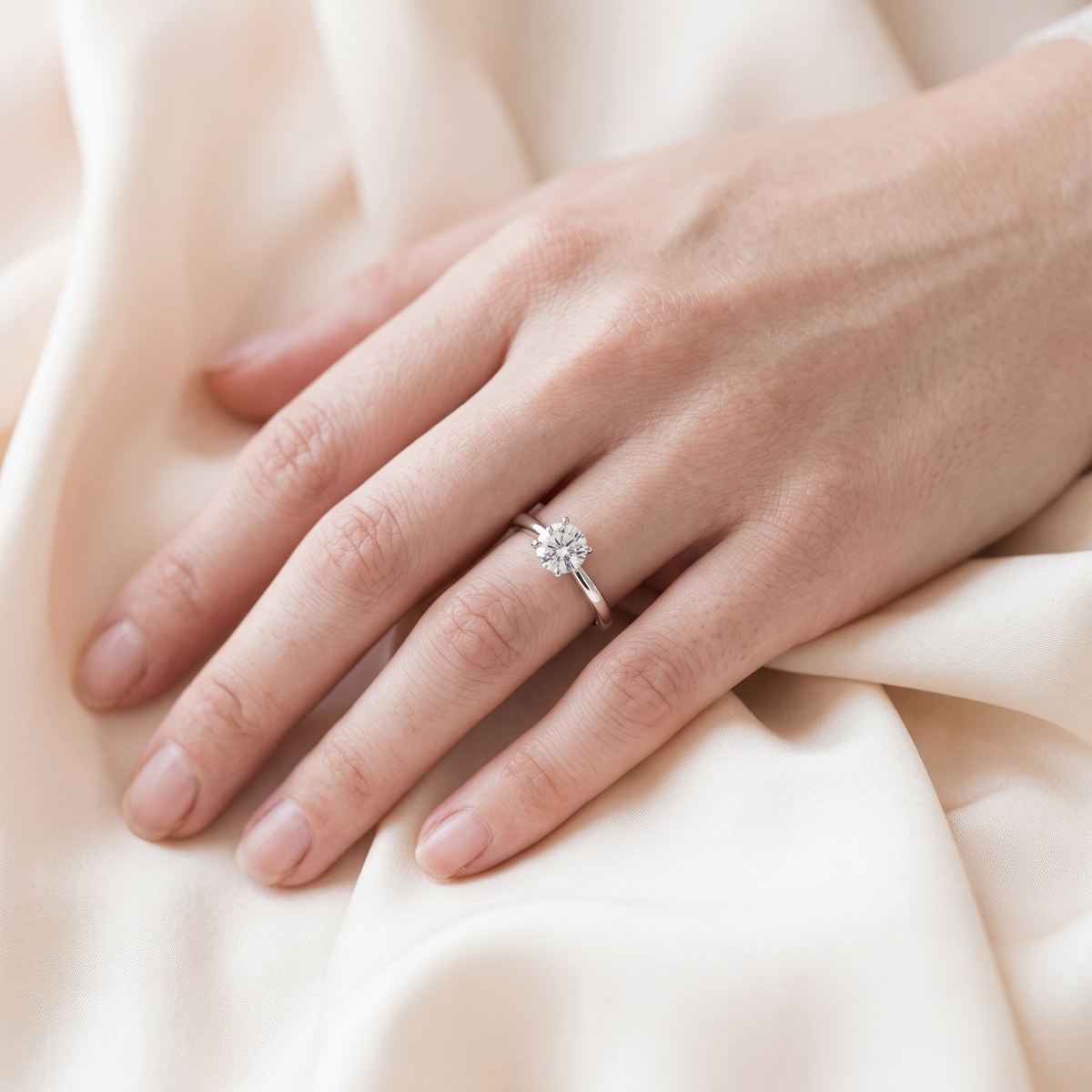1CT brilliant round silver moissanite solitaire worn on a model hand