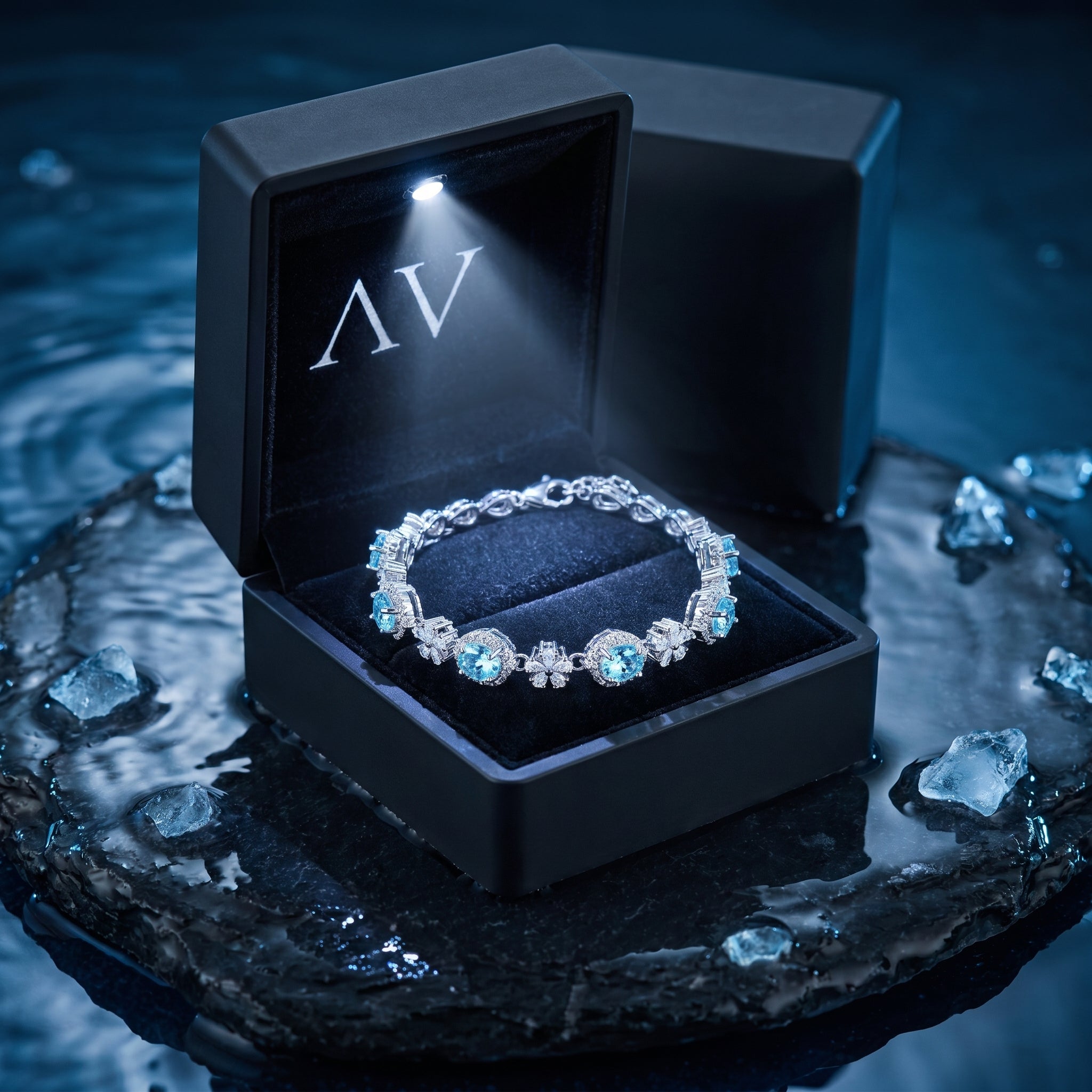Natural aquamarine oval station bracelet presented in a luxury black LED-lit jewelry gift box.