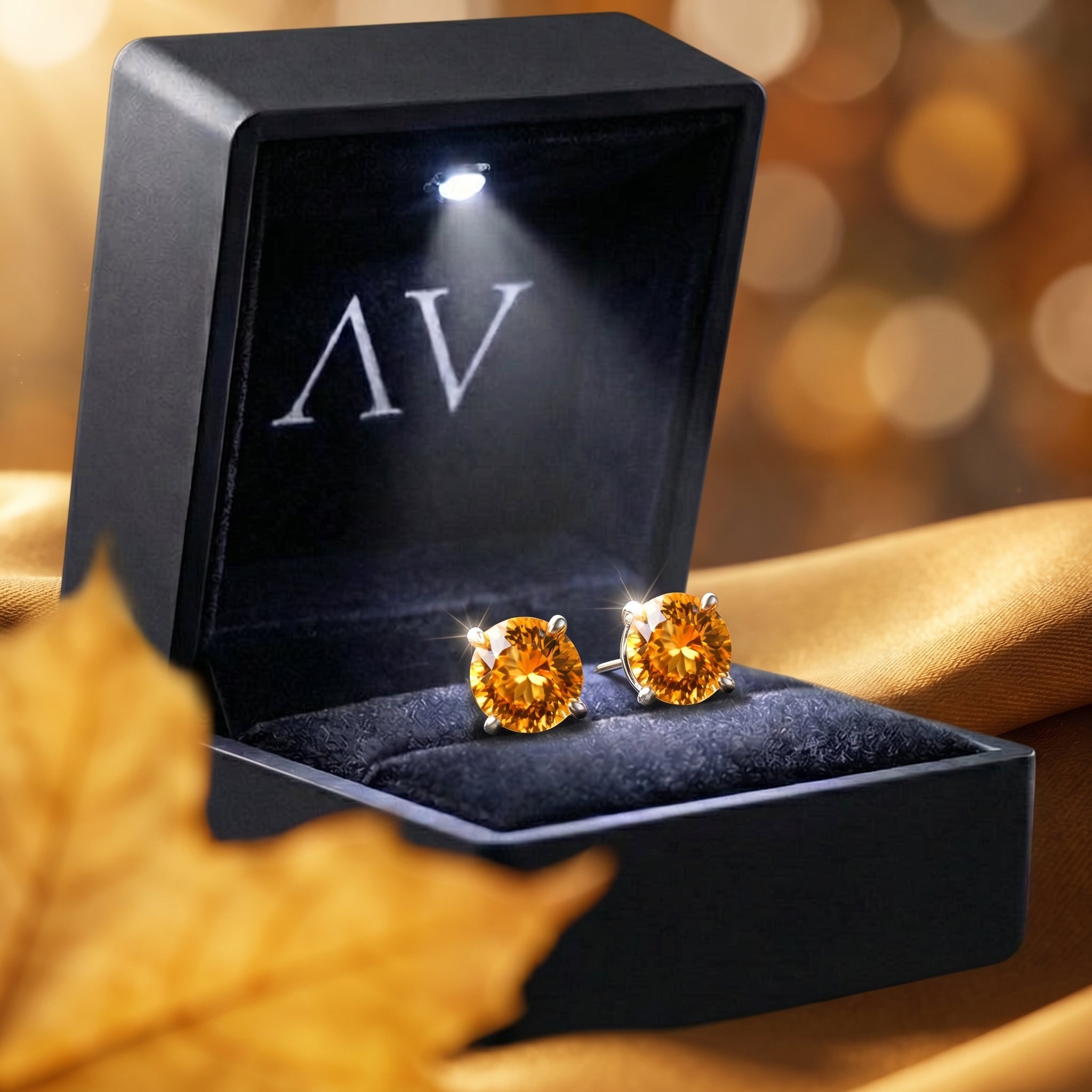 The Aureliana round citrine earrings presented in a black LED-lighted jewelry box for gifting.