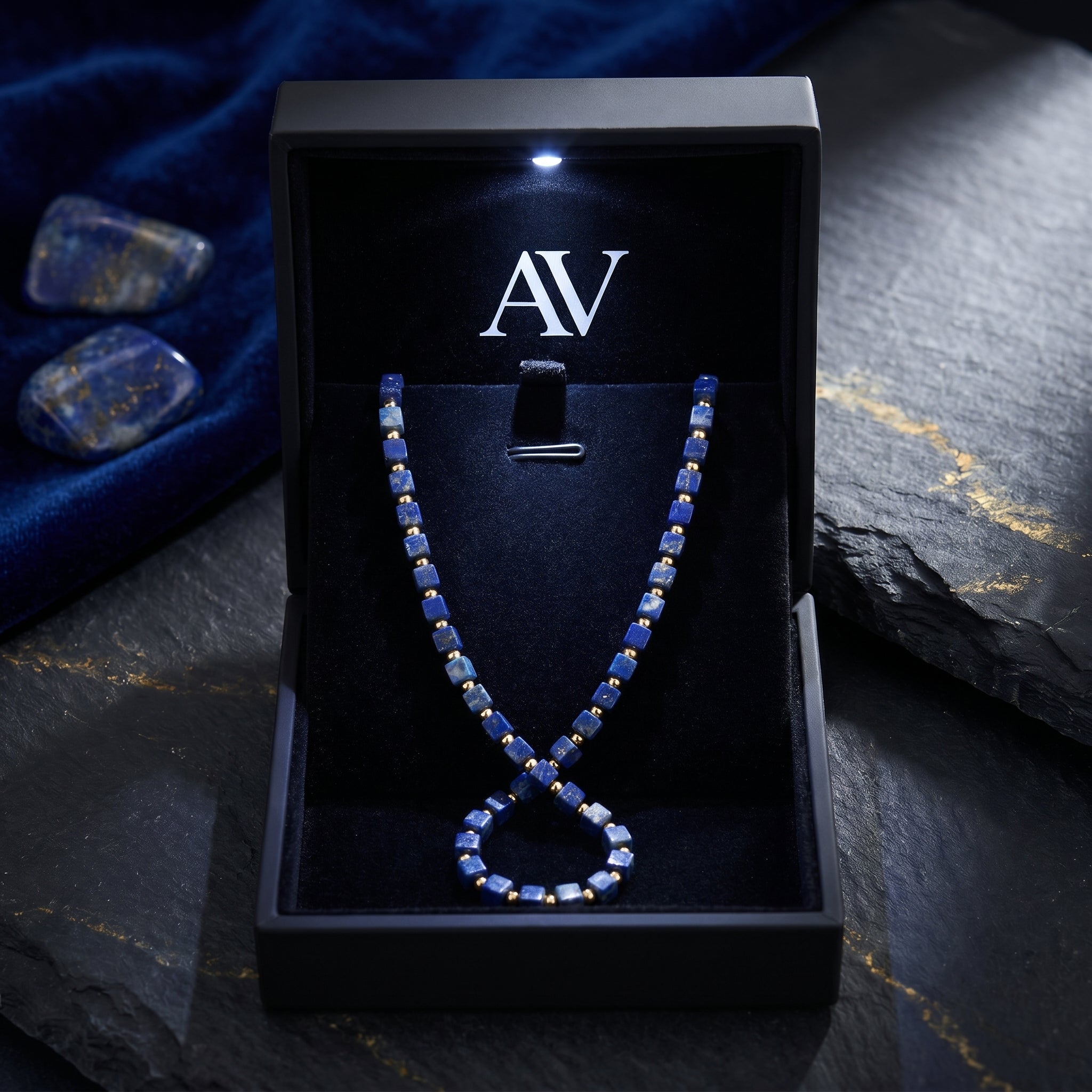 Sovereign Square natural lapis lazuli necklace in a black illuminated gift box with AV branding.