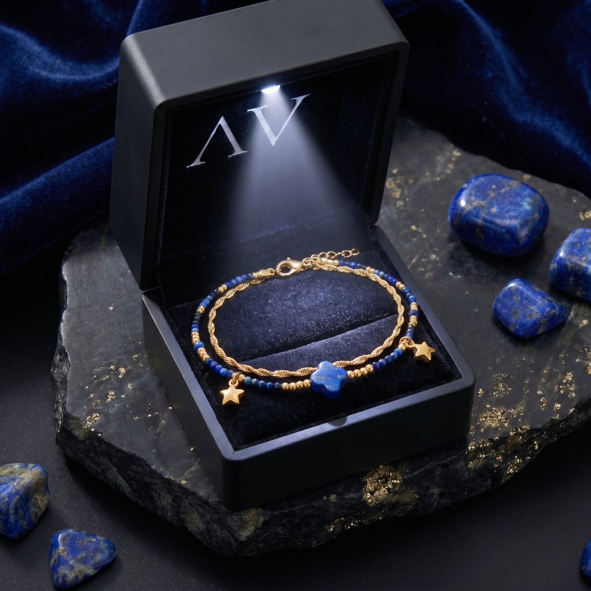 Gold plated stainless steel lapis lazuli bracelet with star charms inside a black LED-lit jewelry gift box.