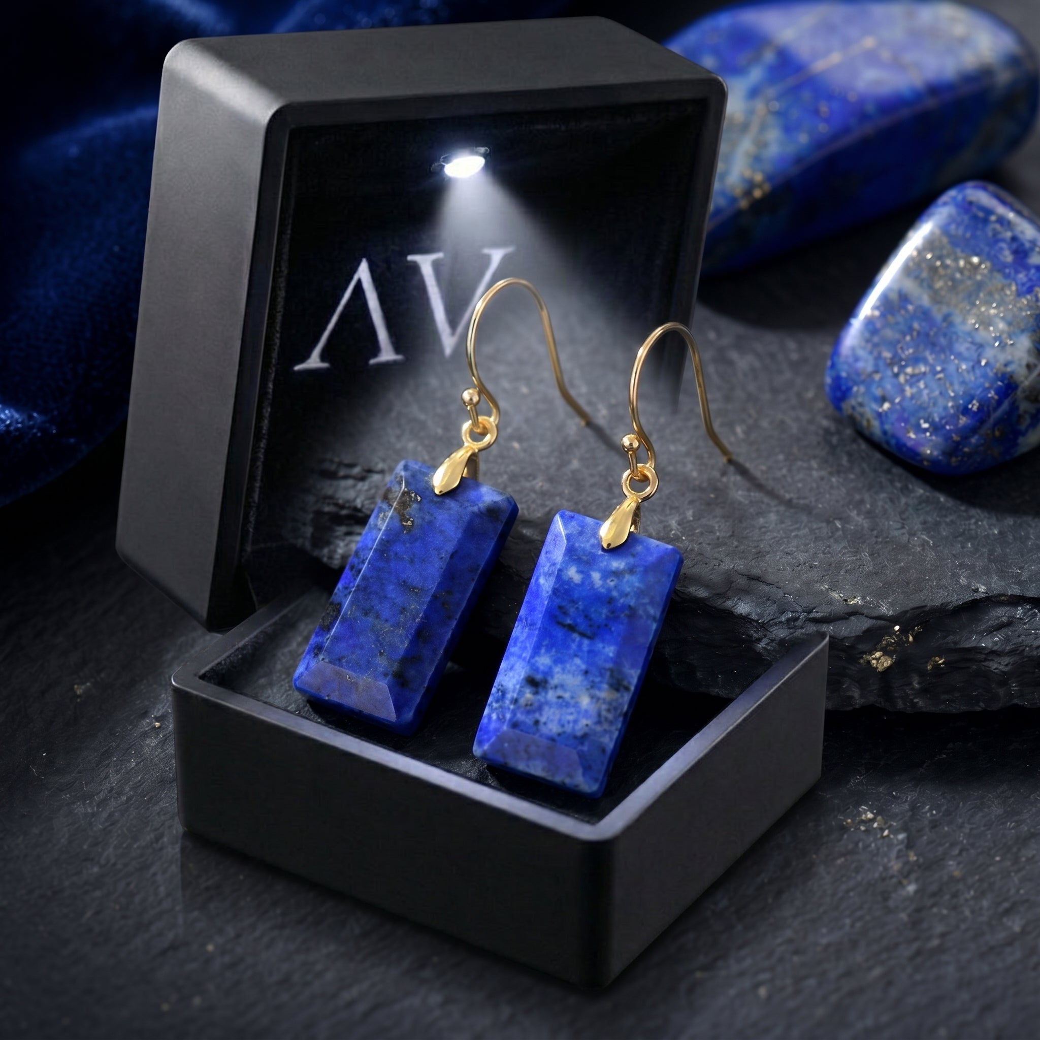 Rectangular natural lapis lazuli drop earrings presented in a black lighted jewelry gift box.