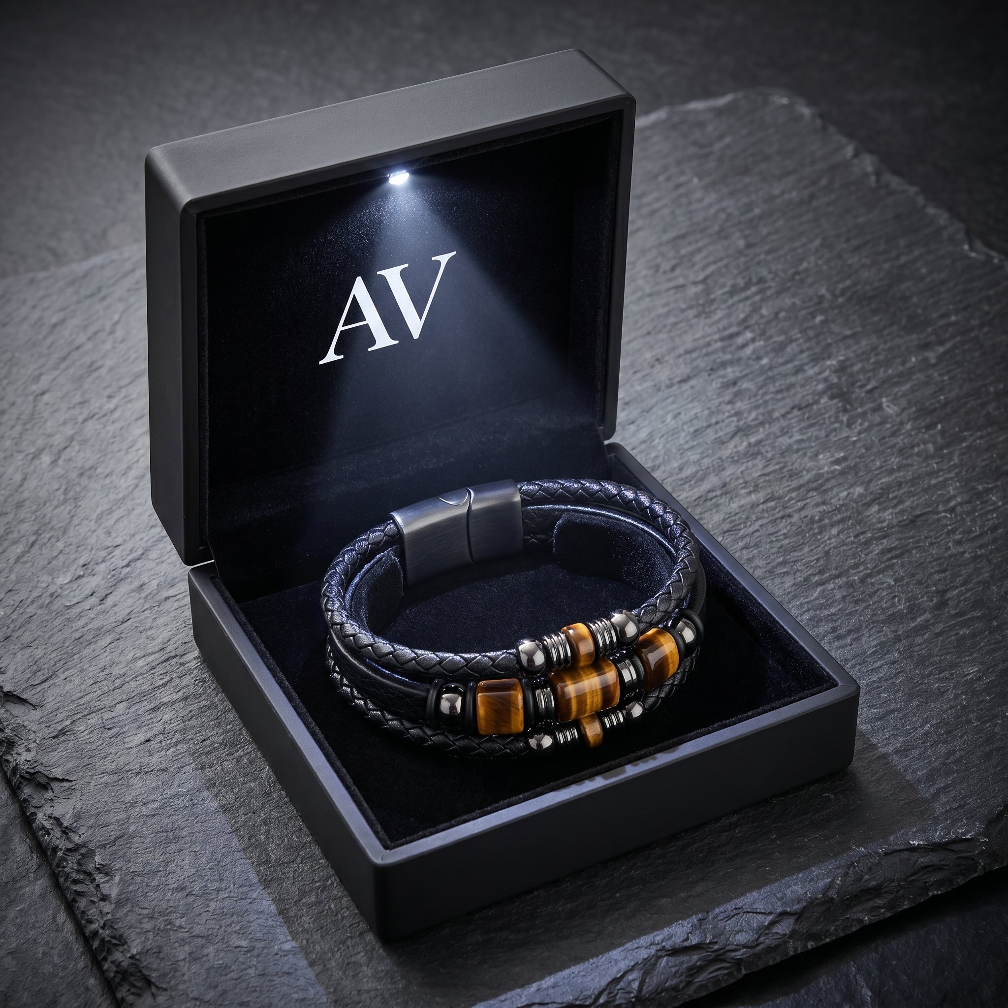 Men's Tiger's Eye and black leather bracelet inside a premium black LED-lit gift box with AV branding.
