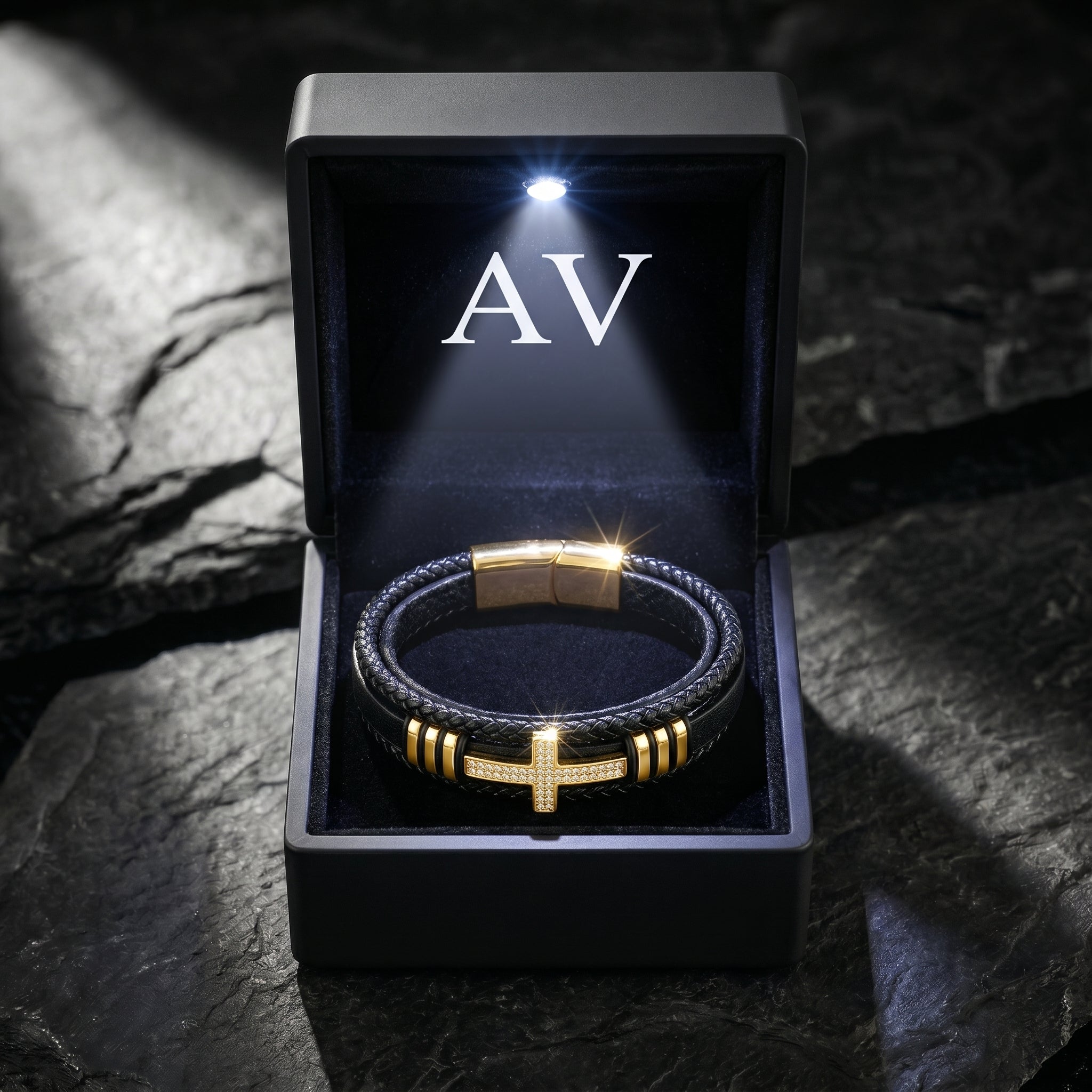Men's gold-finished stainless steel cross bracelet with pavé stones inside a lighted black AV gift box.