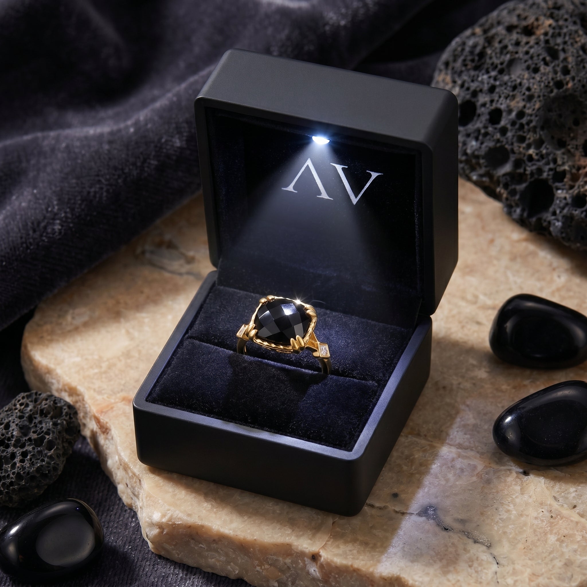 18K gold plated cushion-cut onyx ring inside a black LED-lighted jewelry presentation box.