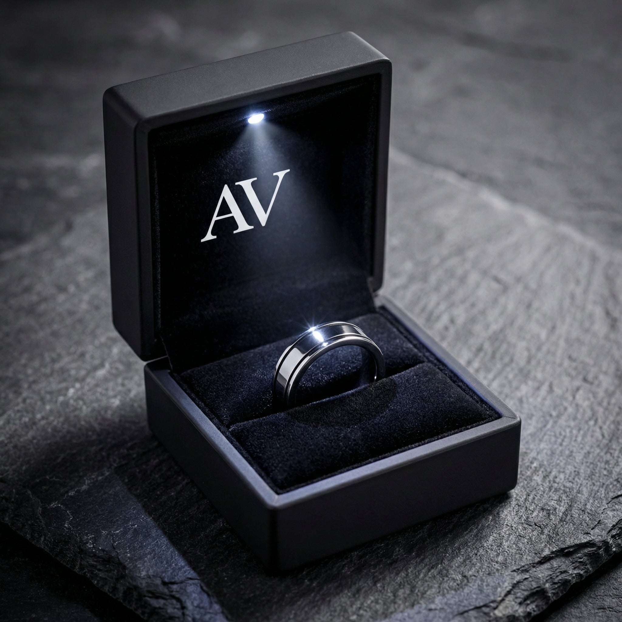 Silver stainless steel Horizon ring presented in a black LED-lit jewelry box with AV branding.