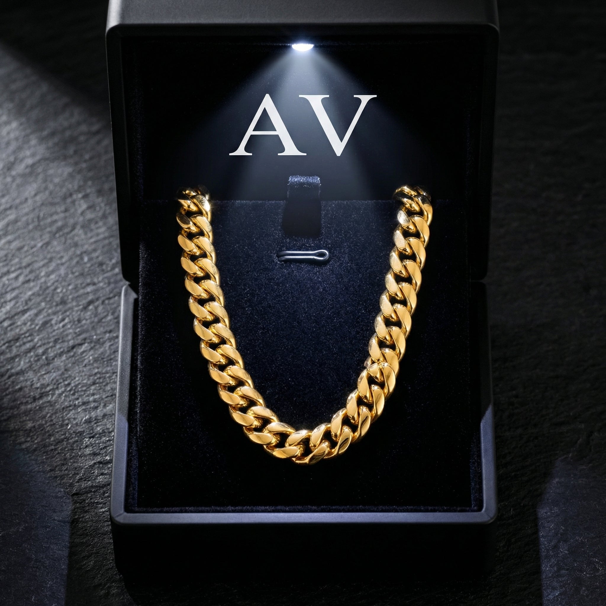 Gold 12mm Cuban link chain presented in a black LED-lighted jewelry box with AV branding.