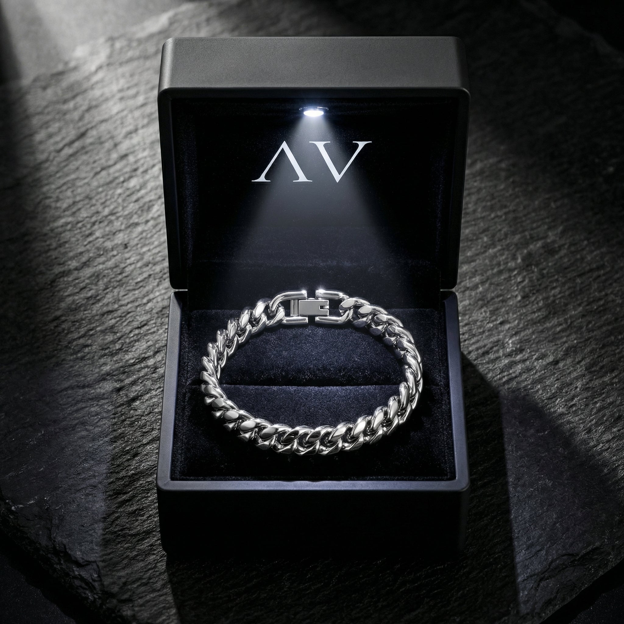 Full view of the silver stainless steel 8mm Cuban link bracelet in a premium lighted jewelry box.
