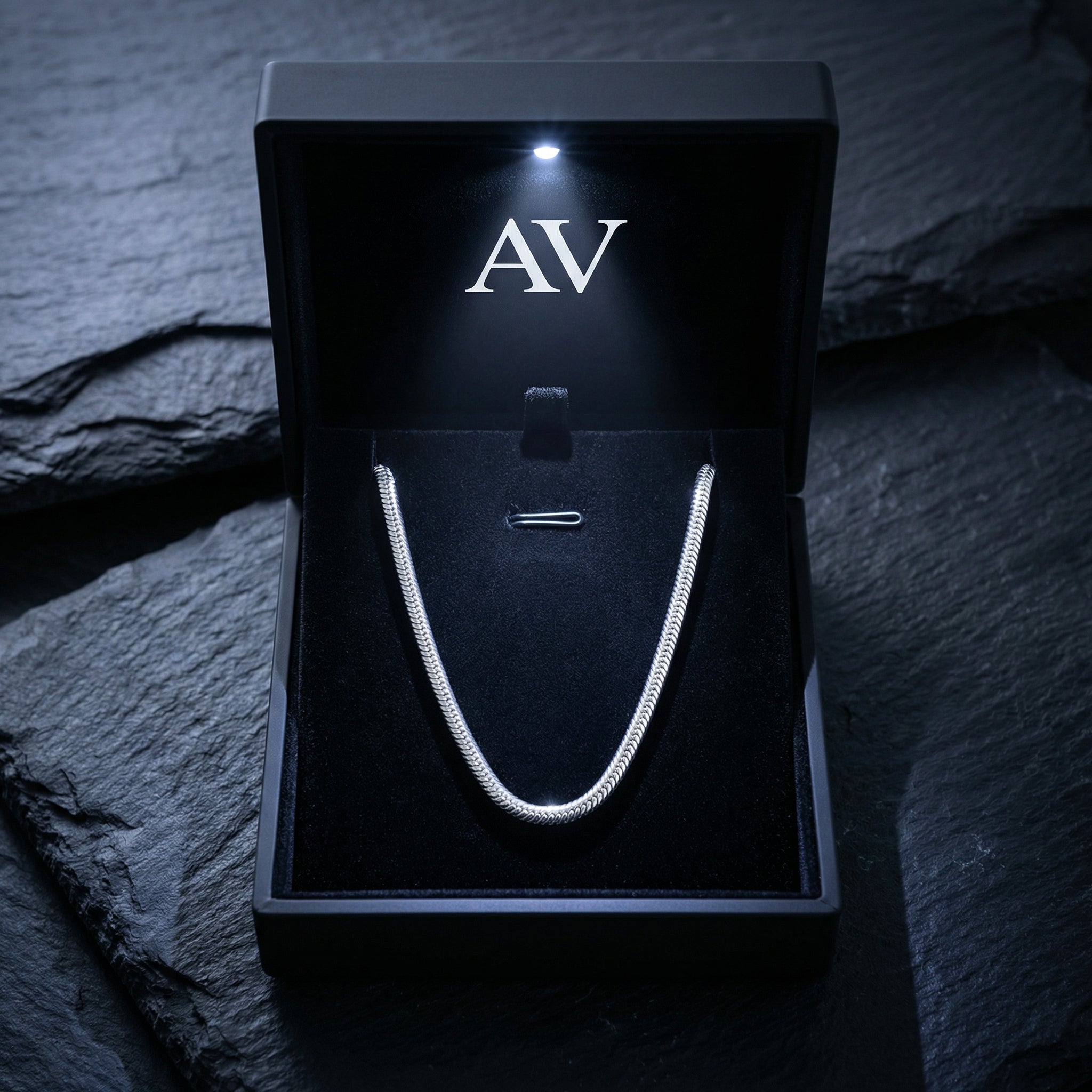 Silver stainless steel square link chain necklace inside a premium lighted black jewelry box with AV logo.