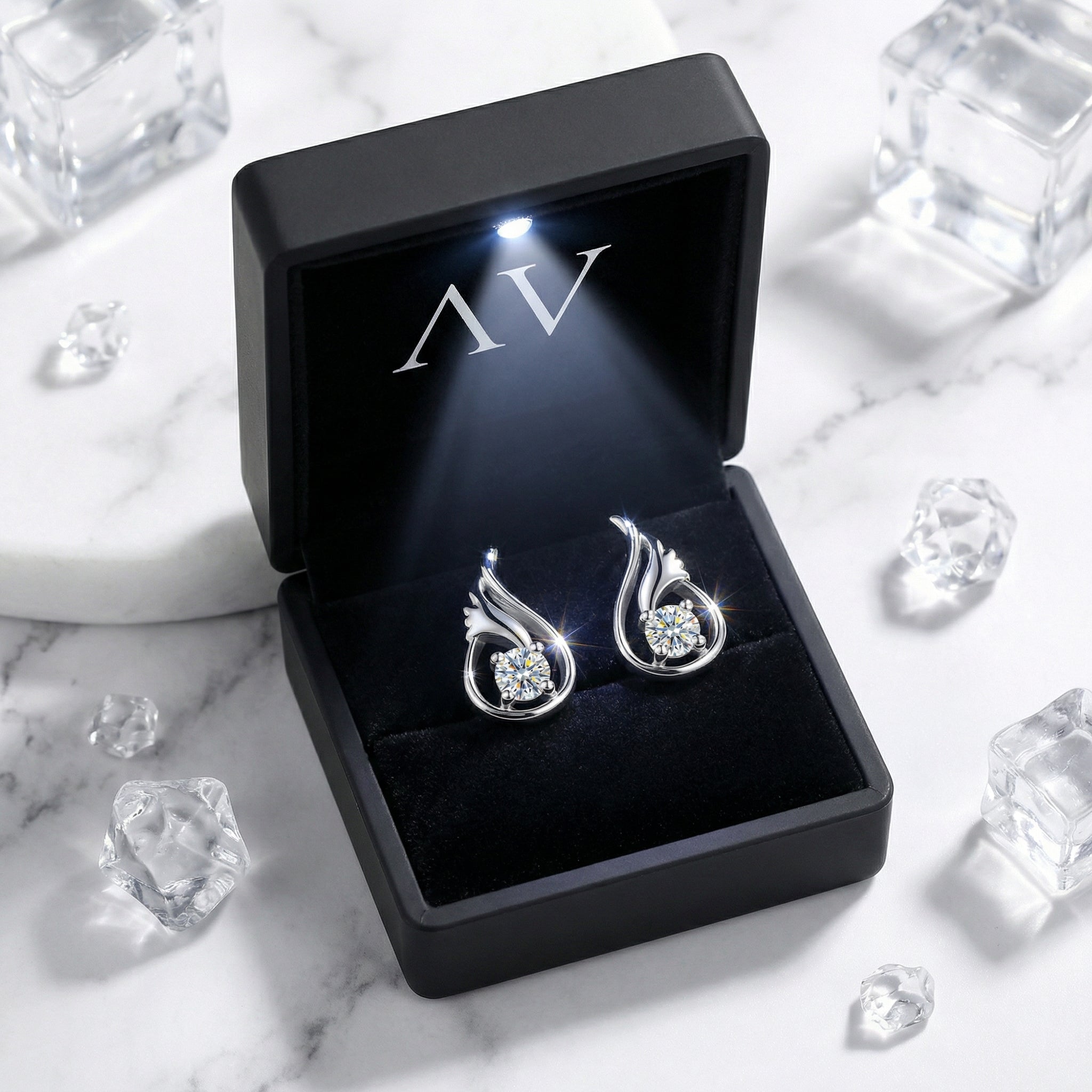 Sterling silver round cut zirconia earrings displayed in a black lighted presentation gift box.