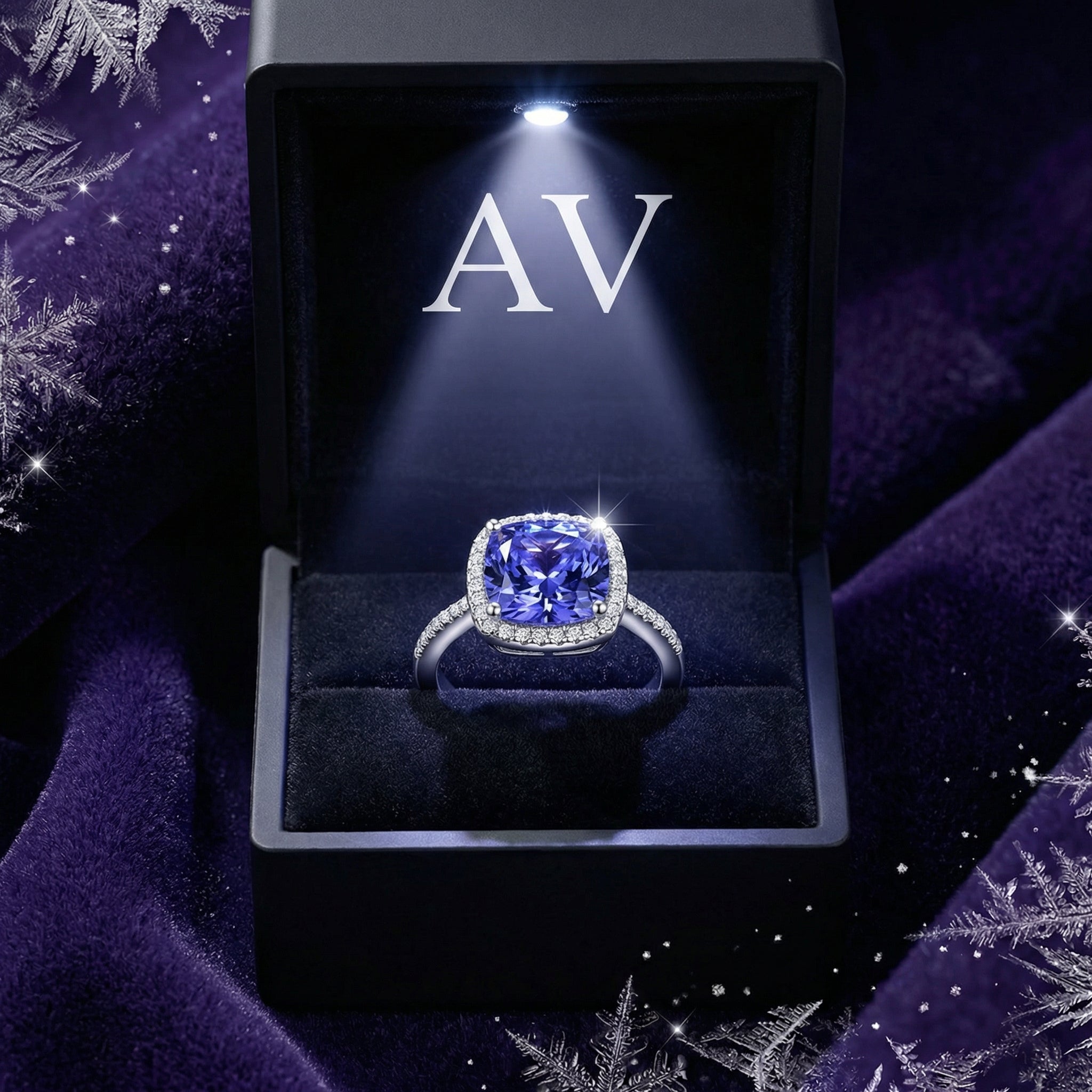 Cushion cut simulated tanzanite sterling silver ring inside a lighted black jewelry presentation box.