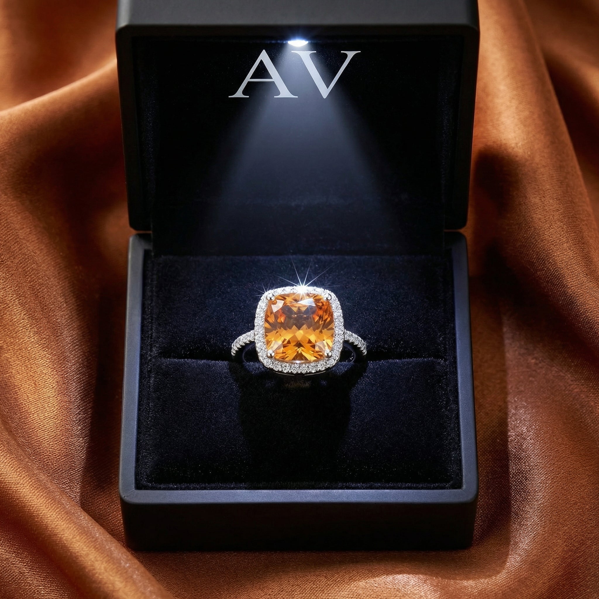 S925 sterling silver cushion-cut simulated topaz ring inside a black LED-lit jewelry box on brown satin.