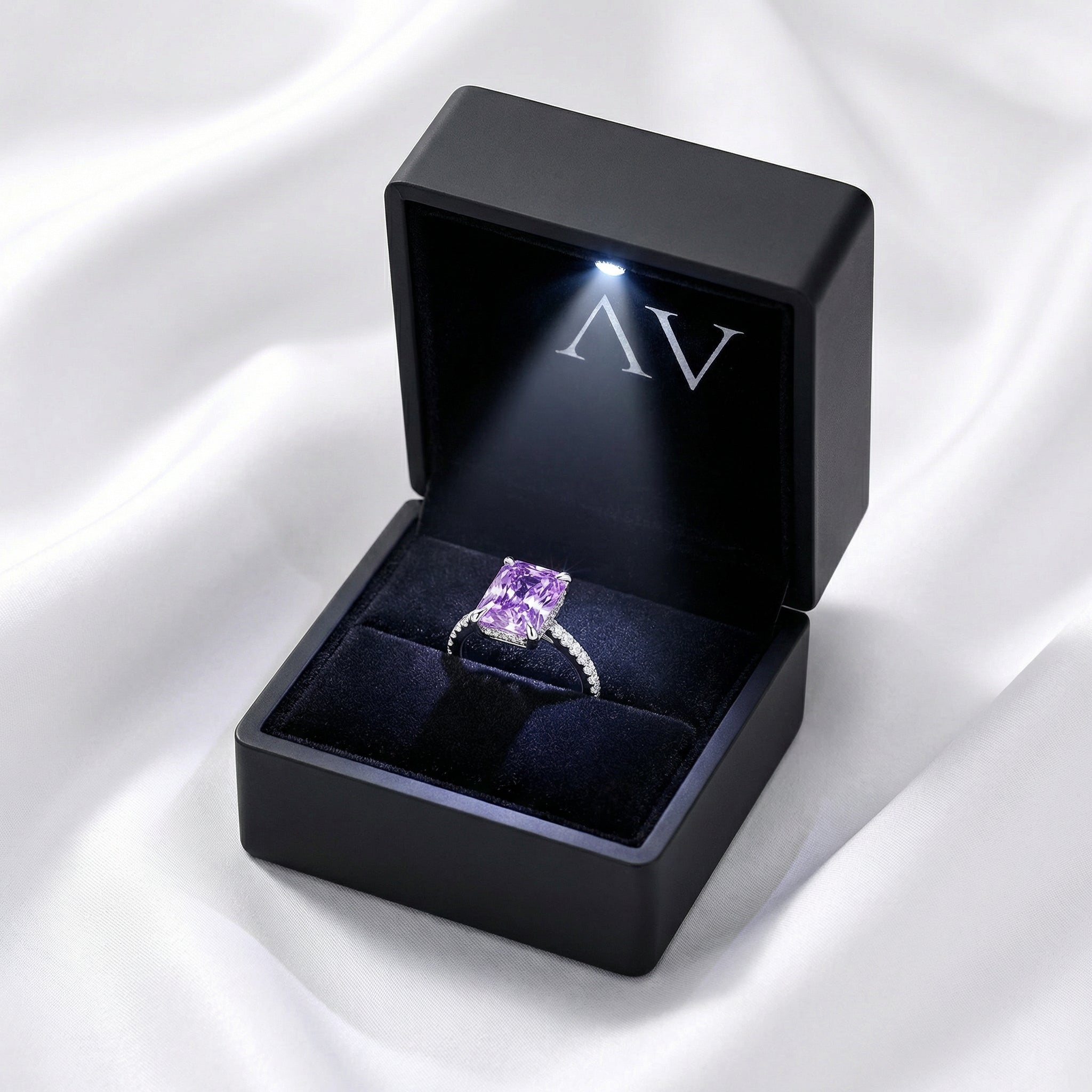 Radiant cut purple simulated amethyst ring in a black LED-lit jewelry presentation box.