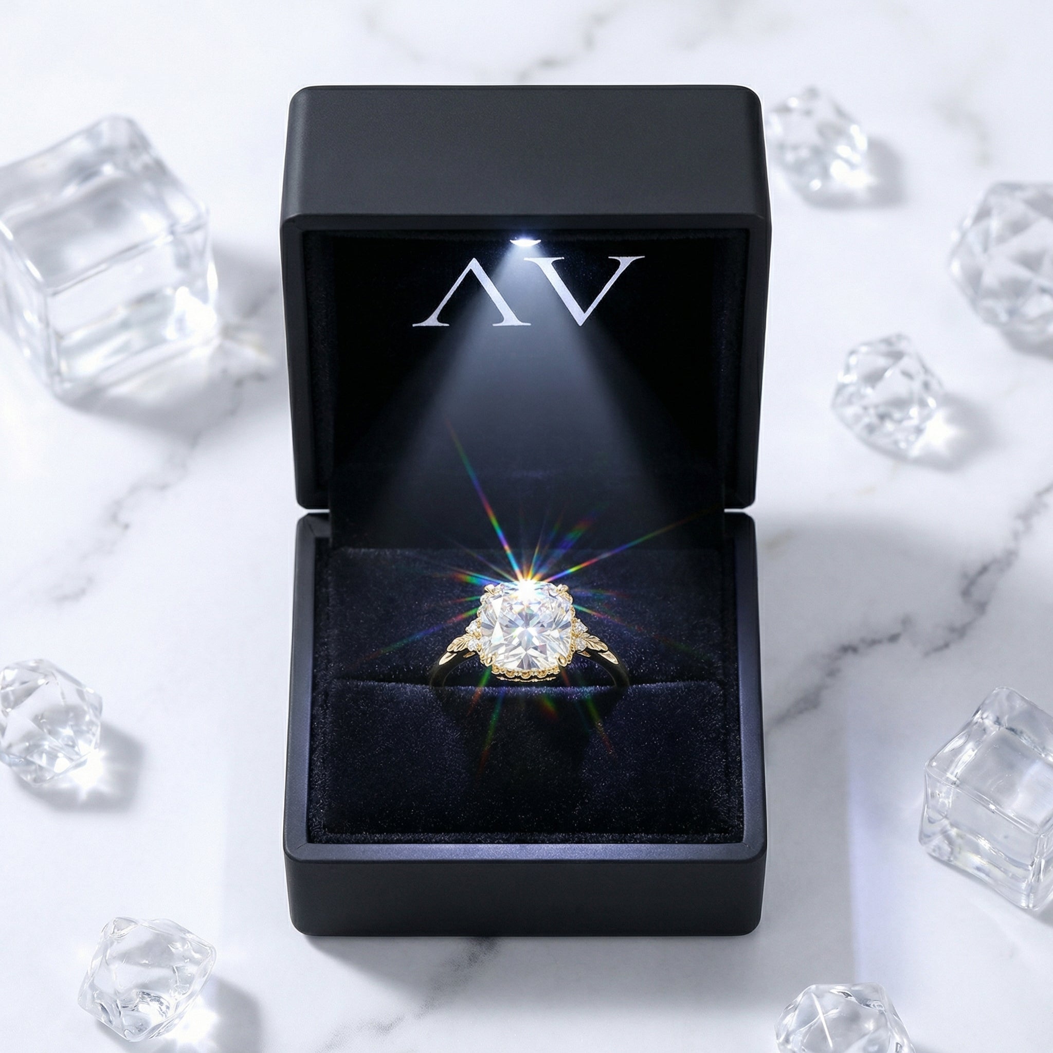 Mirellia 18K gold vermeil cushion cut simulated diamond ring inside a black lighted jewelry presentation box.