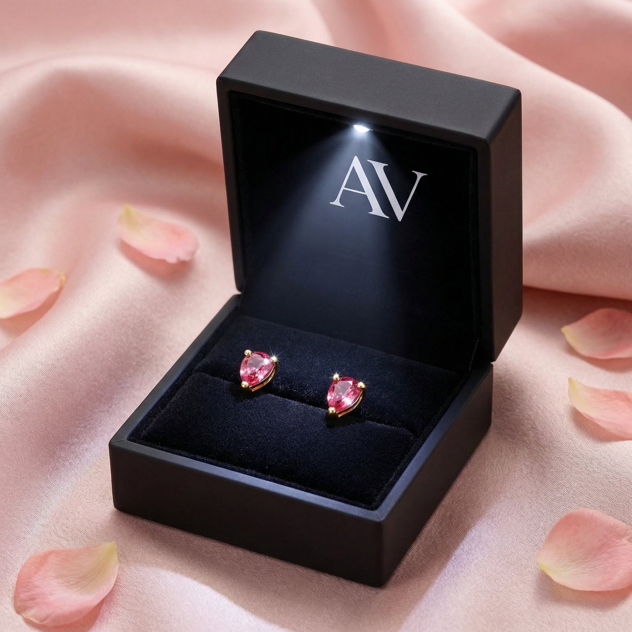 Pair of pear-cut simulated pink tourmaline earrings in 18K gold vermeil inside a black LED-lit gift box.