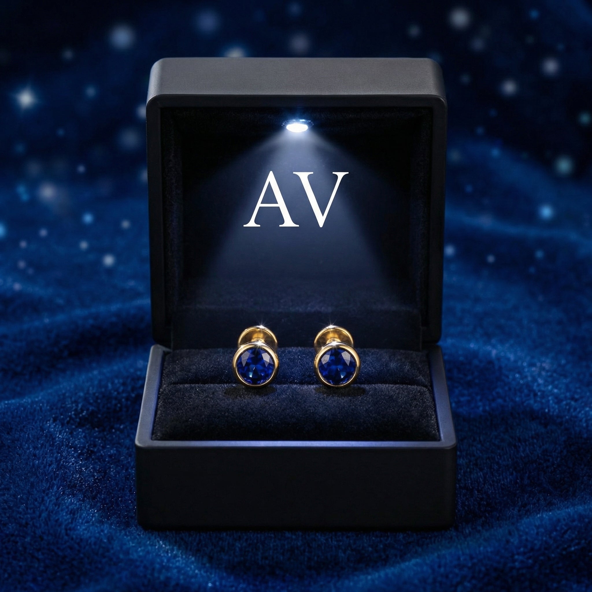 Round simulated sapphire bezel stud earrings in 18K gold vermeil inside a lighted black AV gift box.