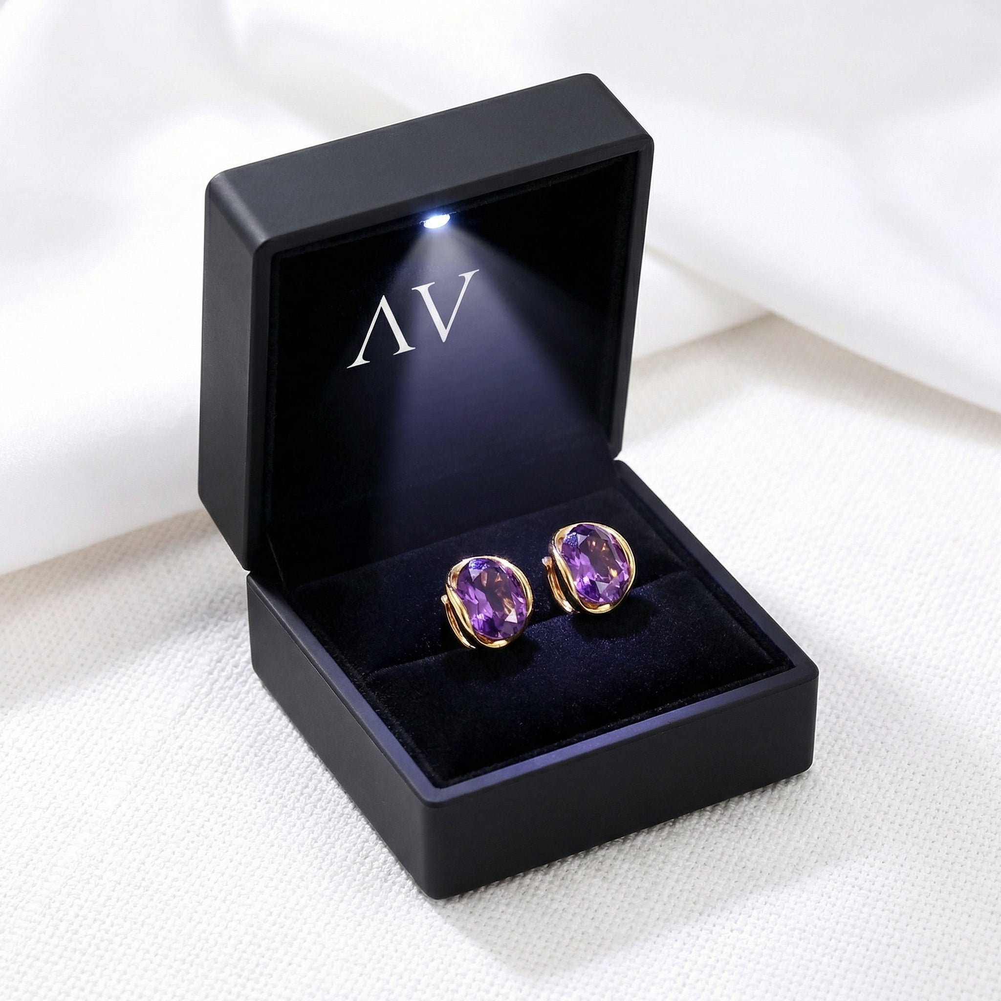 18K gold vermeil simulated amethyst hoop earrings inside a black LED-lit branded jewelry presentation box.