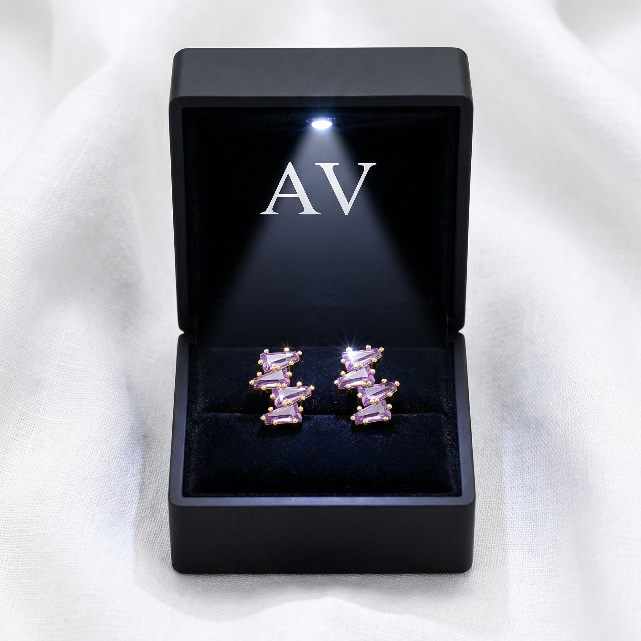Callista cluster earrings in 18K gold vermeil with simulated amethyst in a black LED-lit presentation box.