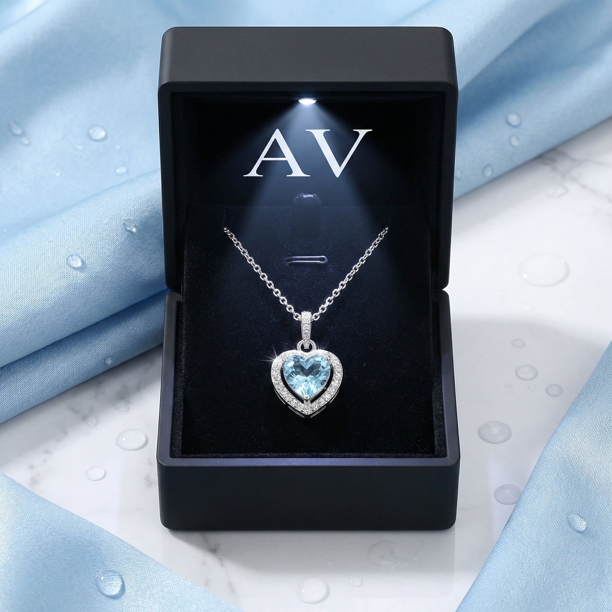 Heart cut simulated aquamarine necklace in a black LED-lit jewelry presentation box.