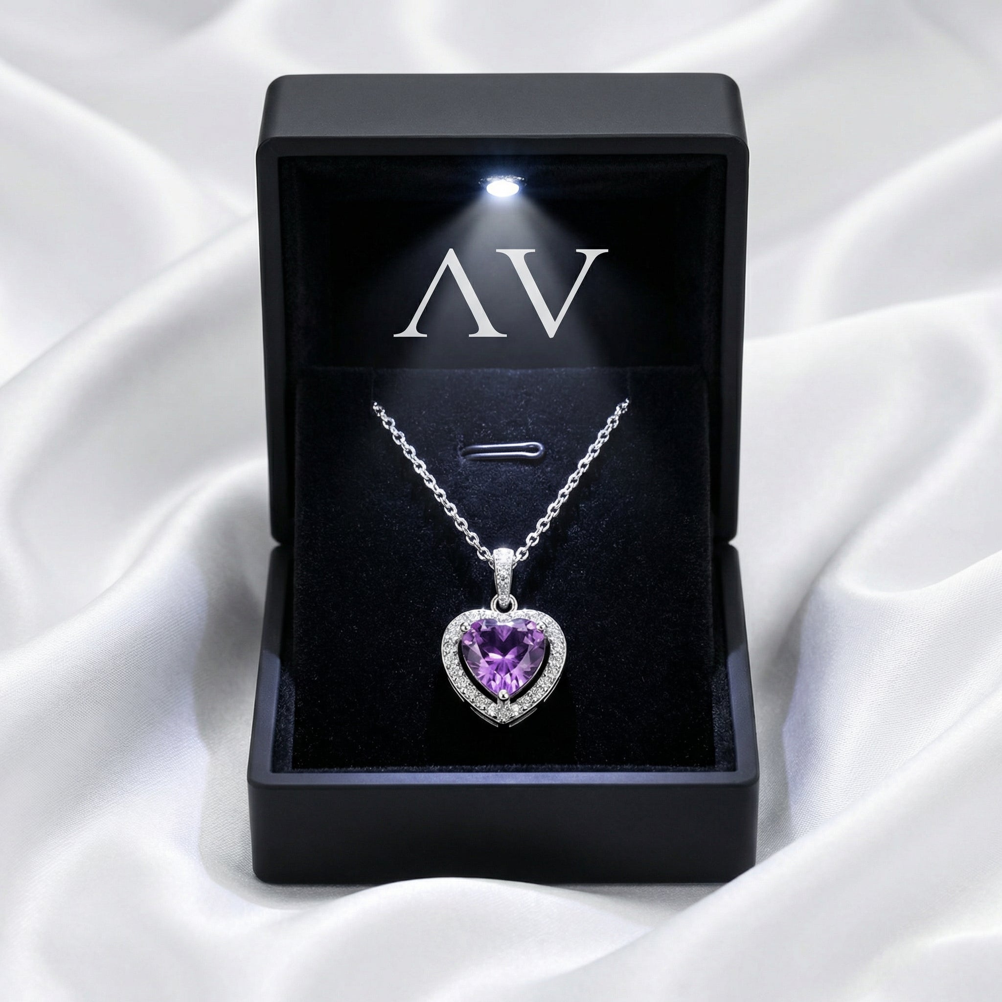 Heart-cut simulated amethyst sterling silver necklace in a black LED-lit gift box on white satin.