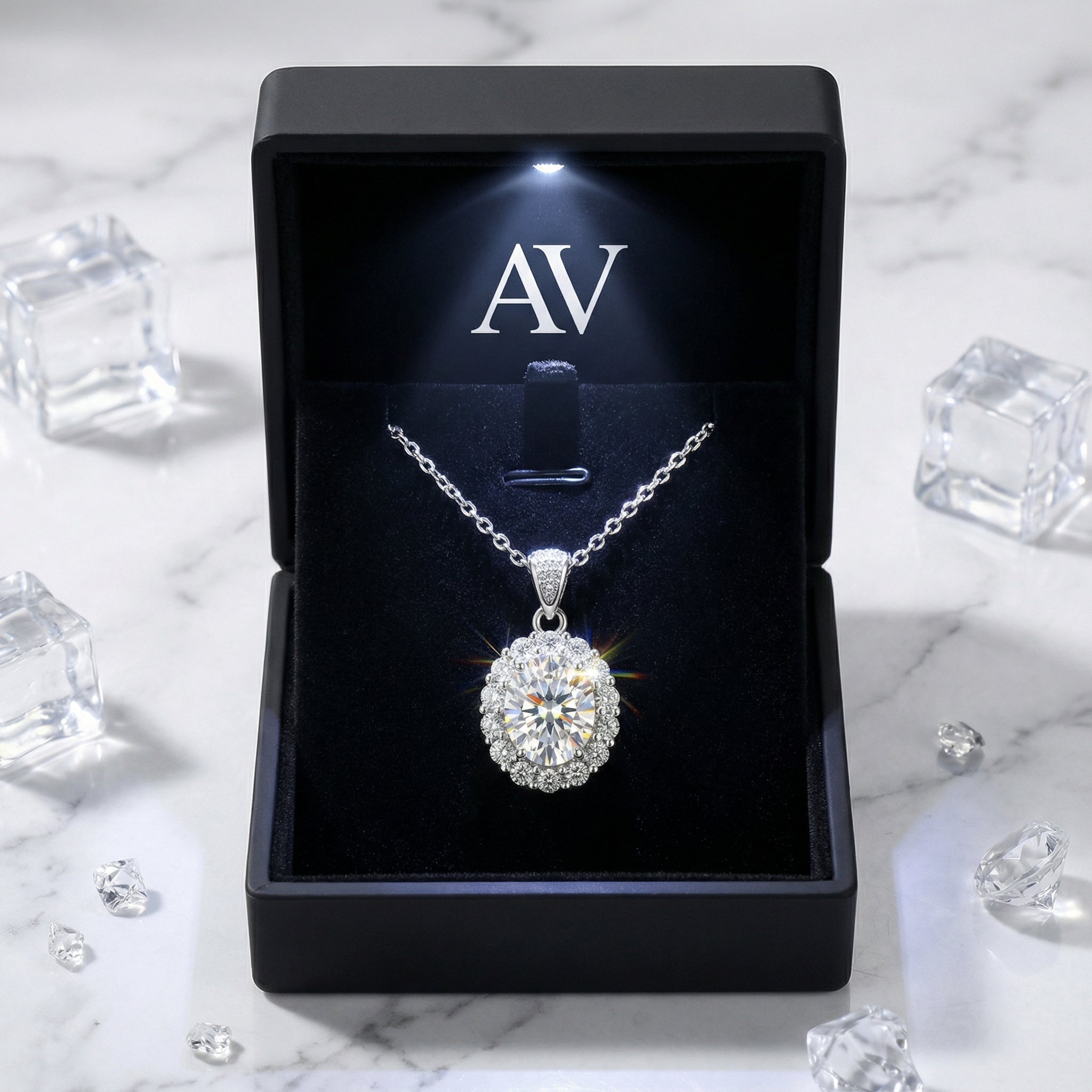 April birthstone oval halo necklace in a black LED-lighted AV presentation box on marble.