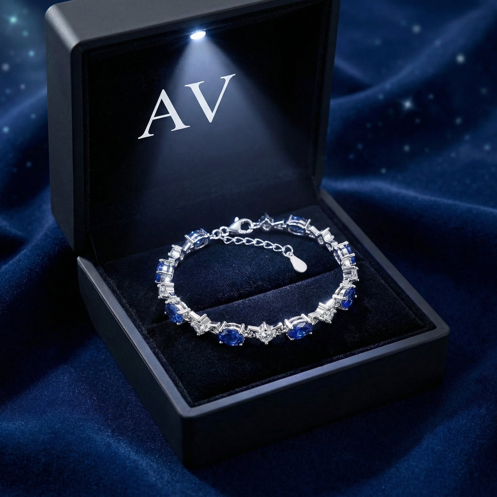 Neriselle blue simulated sapphire bracelet in a premium black LED-lit gift box with AV branding.