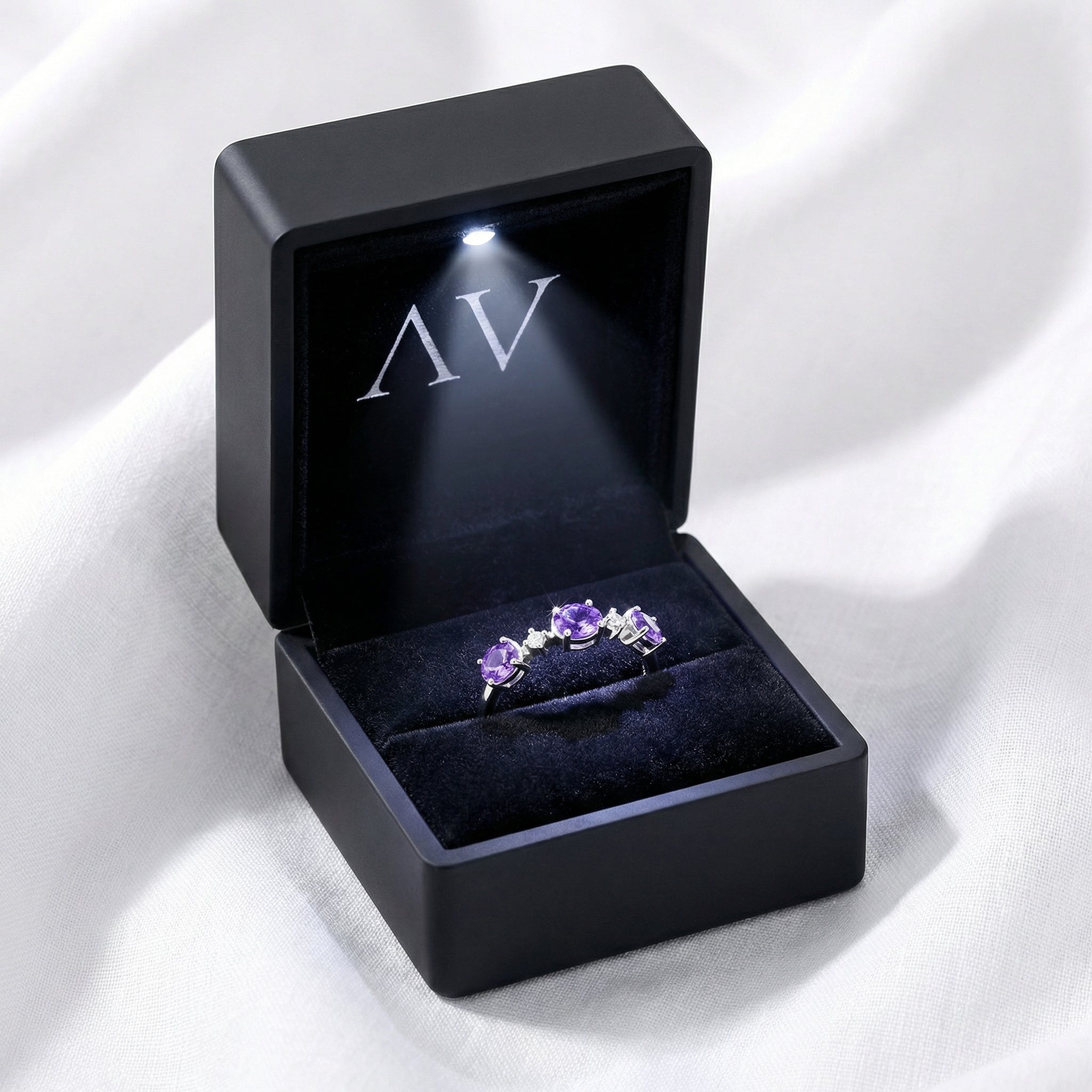 Serenitas S925 sterling silver simulated amethyst ring inside a black LED-lit jewelry presentation box.