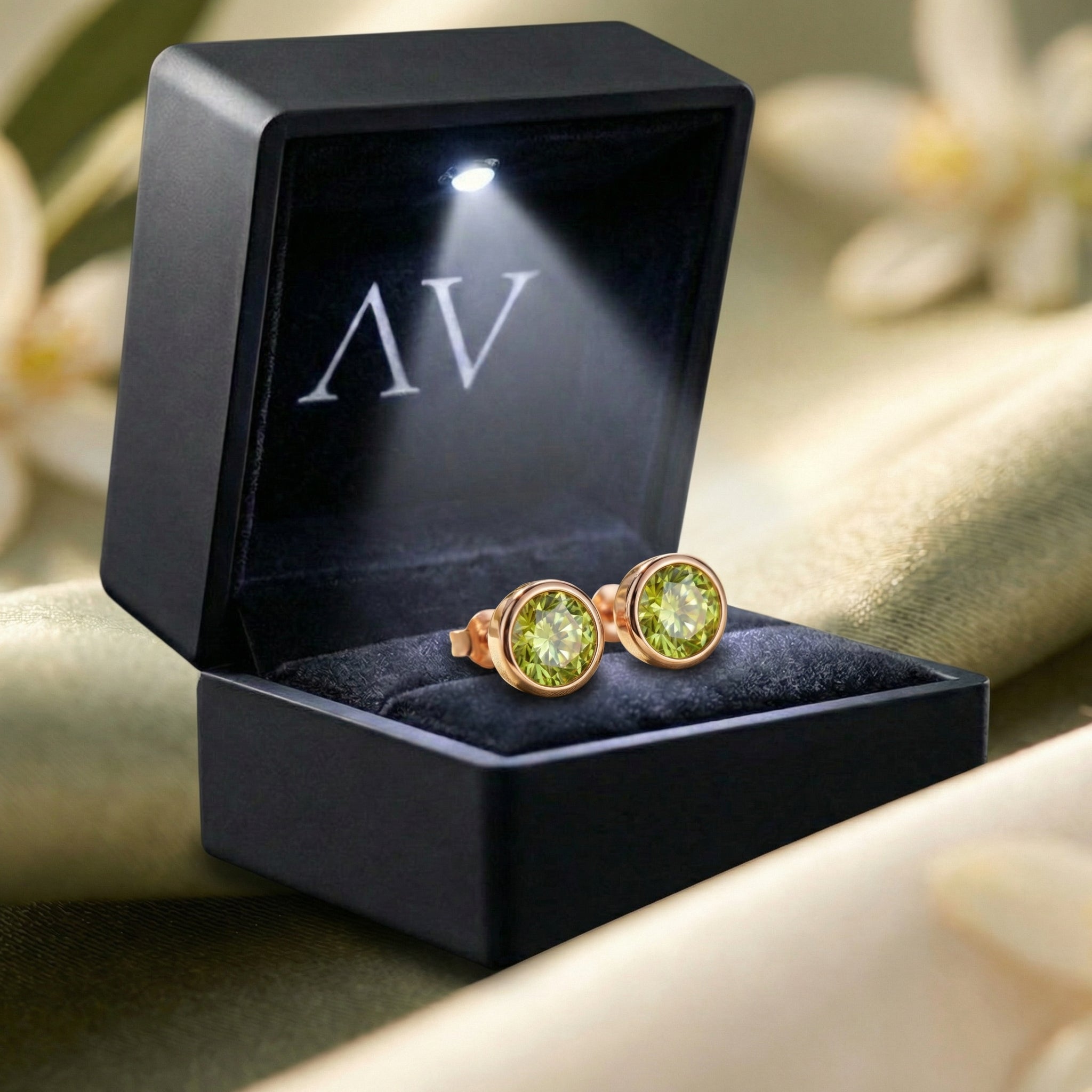 Natural peridot stud earrings in 18K rose gold vermeil presented in a black LED-lit jewelry gift box.