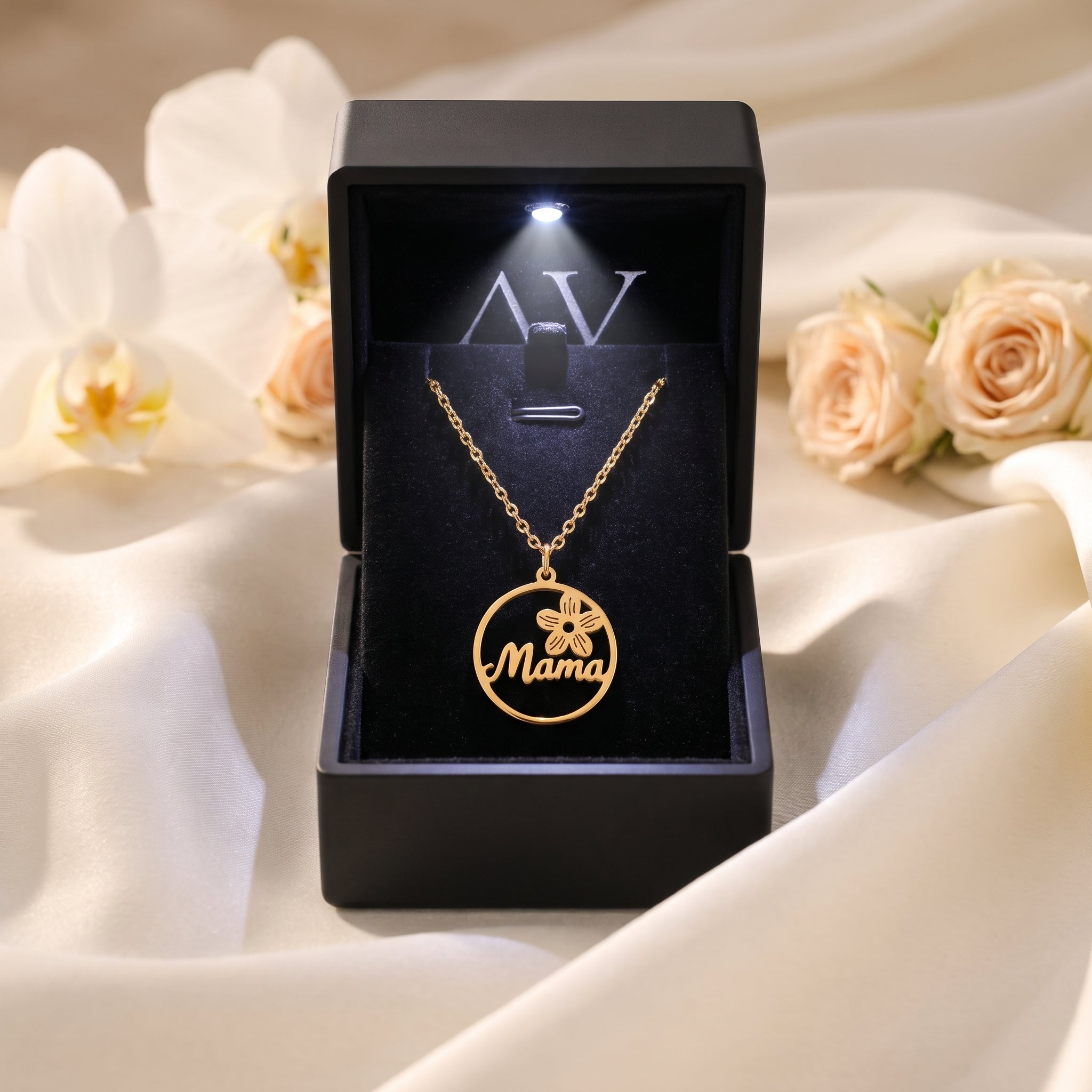 Gold Elyssa Mama necklace inside a black LED-lit gift box.