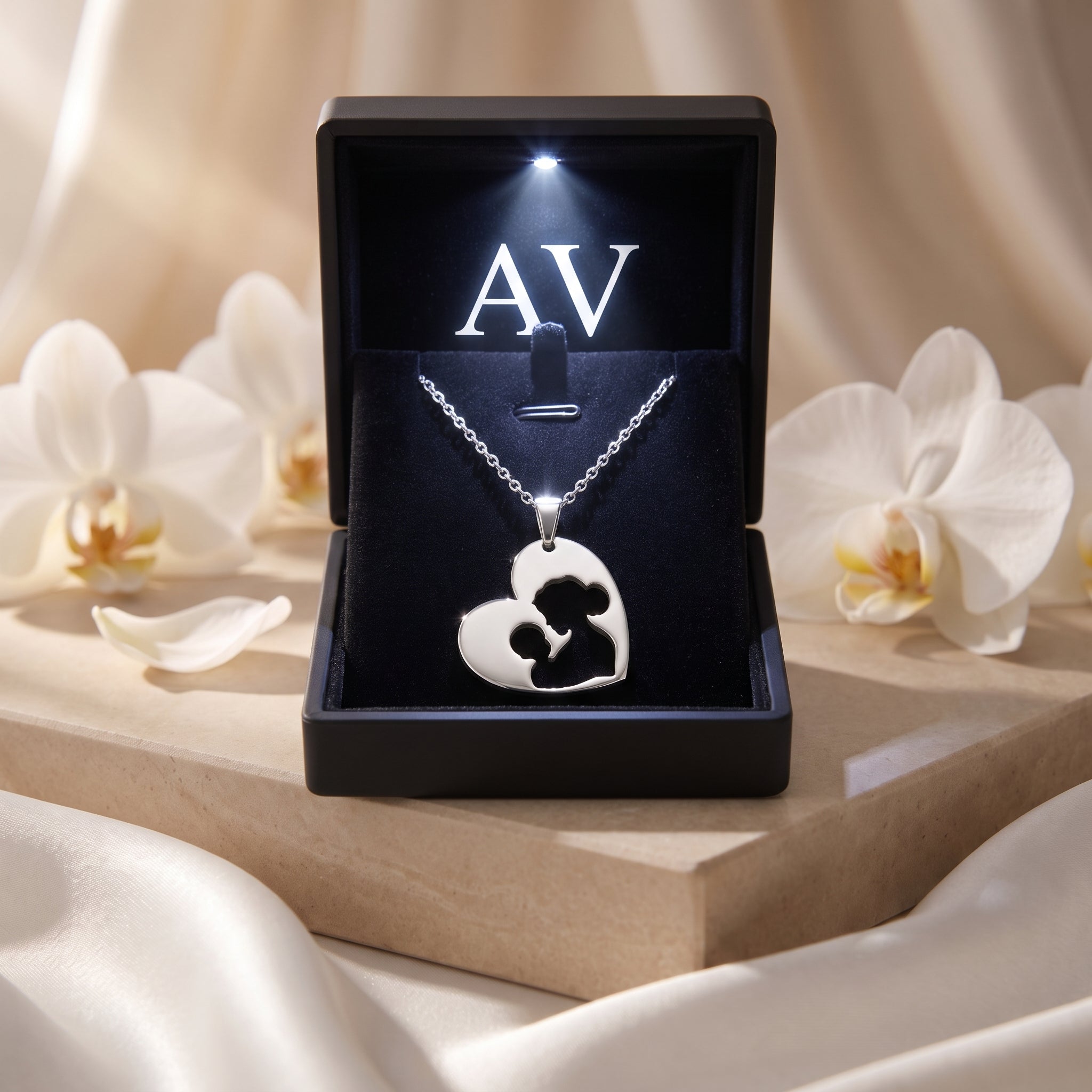 Silver stainless steel heart cutout necklace in an LED-lit black gift box.