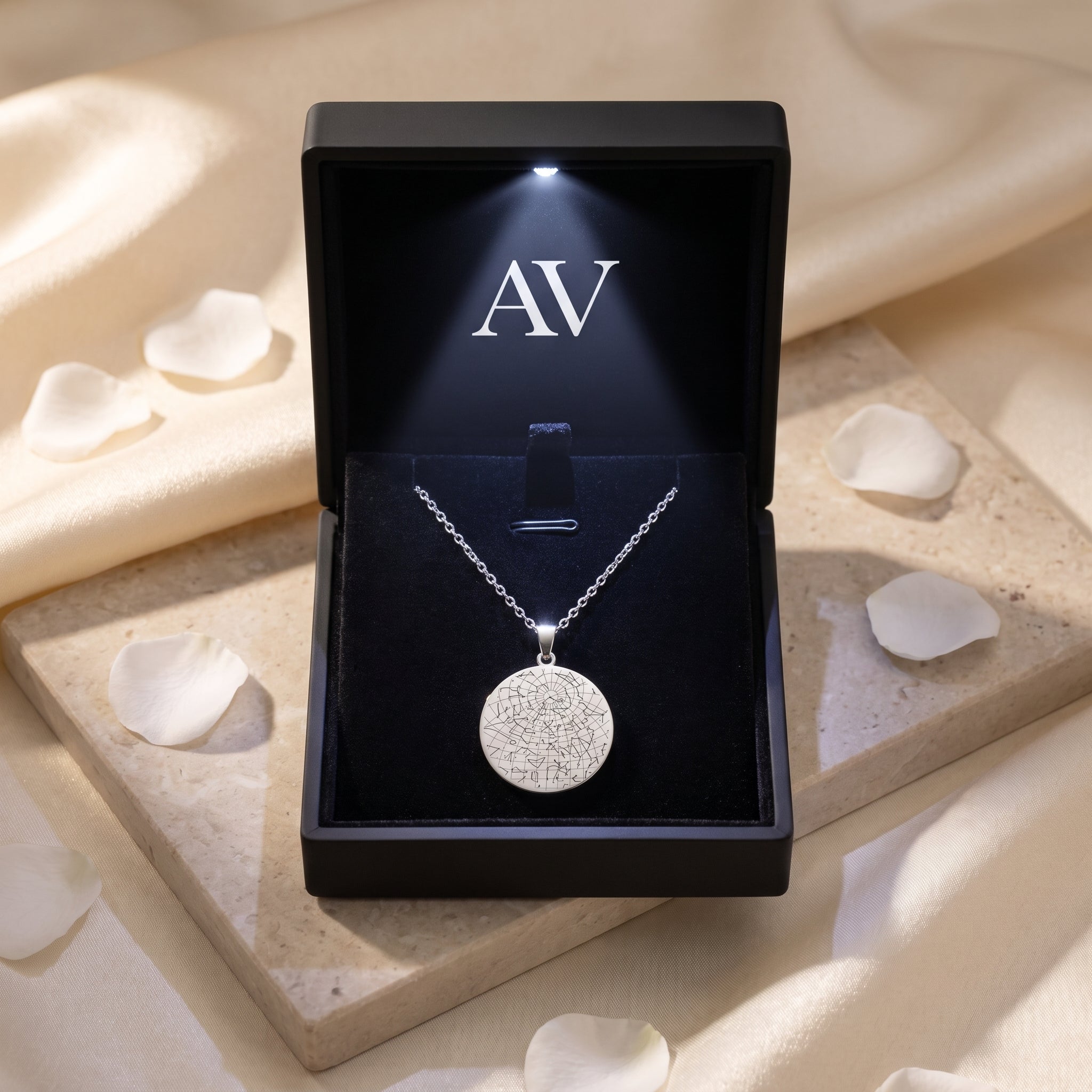 Silver stainless steel star map necklace in a black LED-lit gift box.