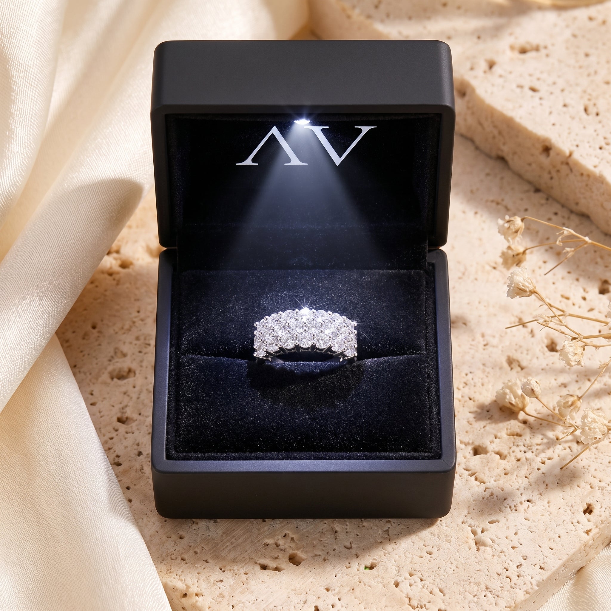 Three-row sterling silver cubic zirconia ring in an LED-lit black jewelry box.