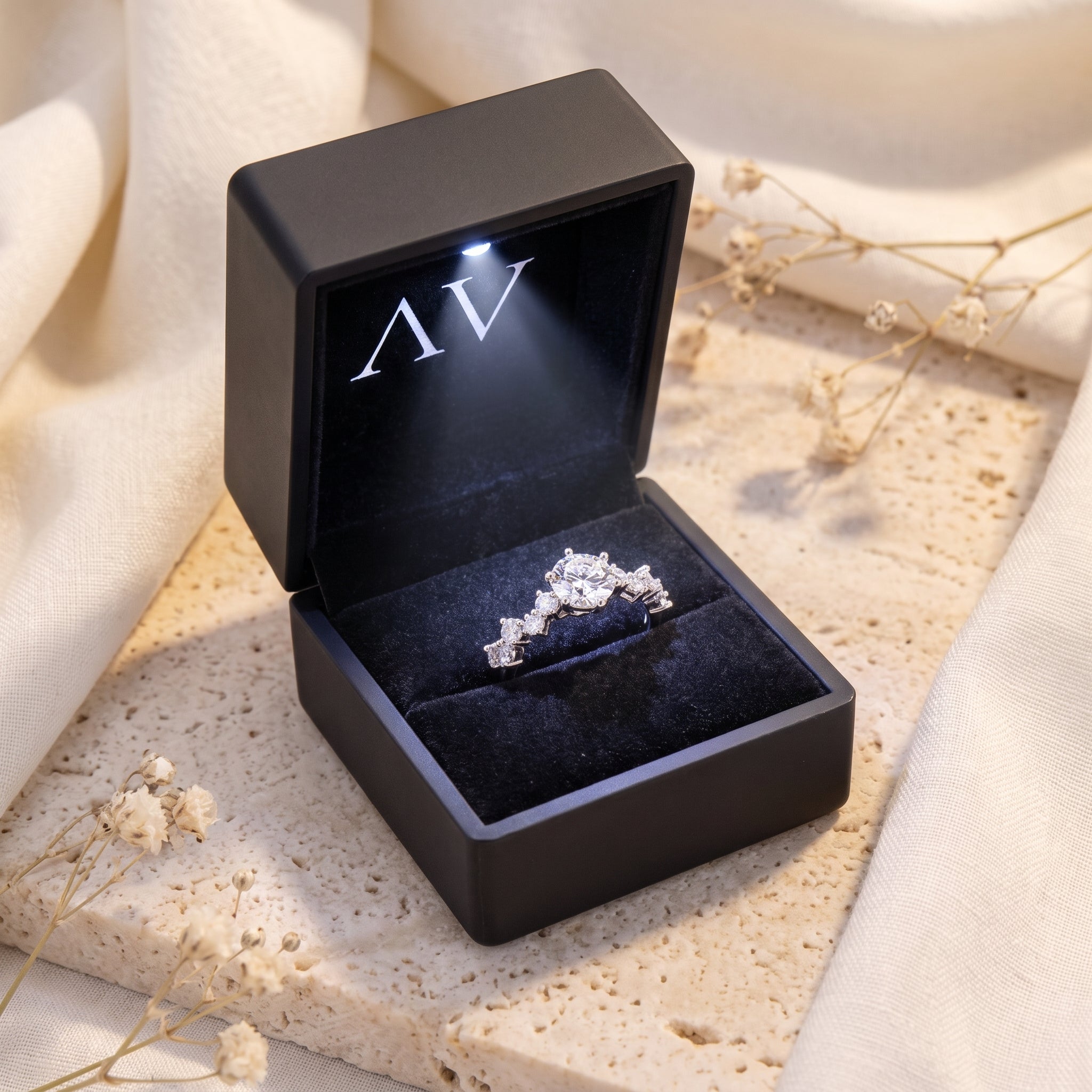 Silver Aura tiara ring in a black LED-lit jewelry gift box.