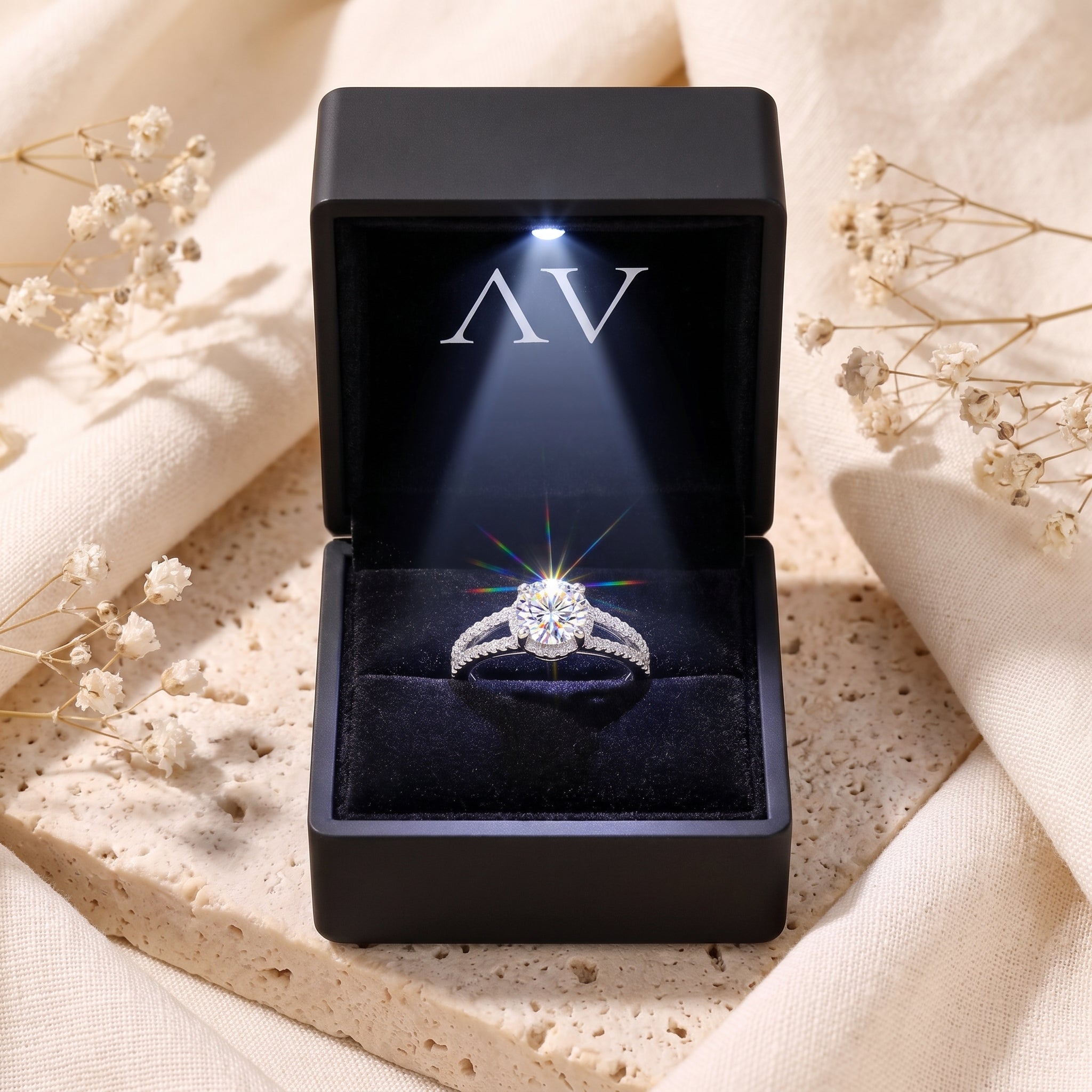 Aria split shank ring inside a black LED-lit jewelry box on a lifestyle background.