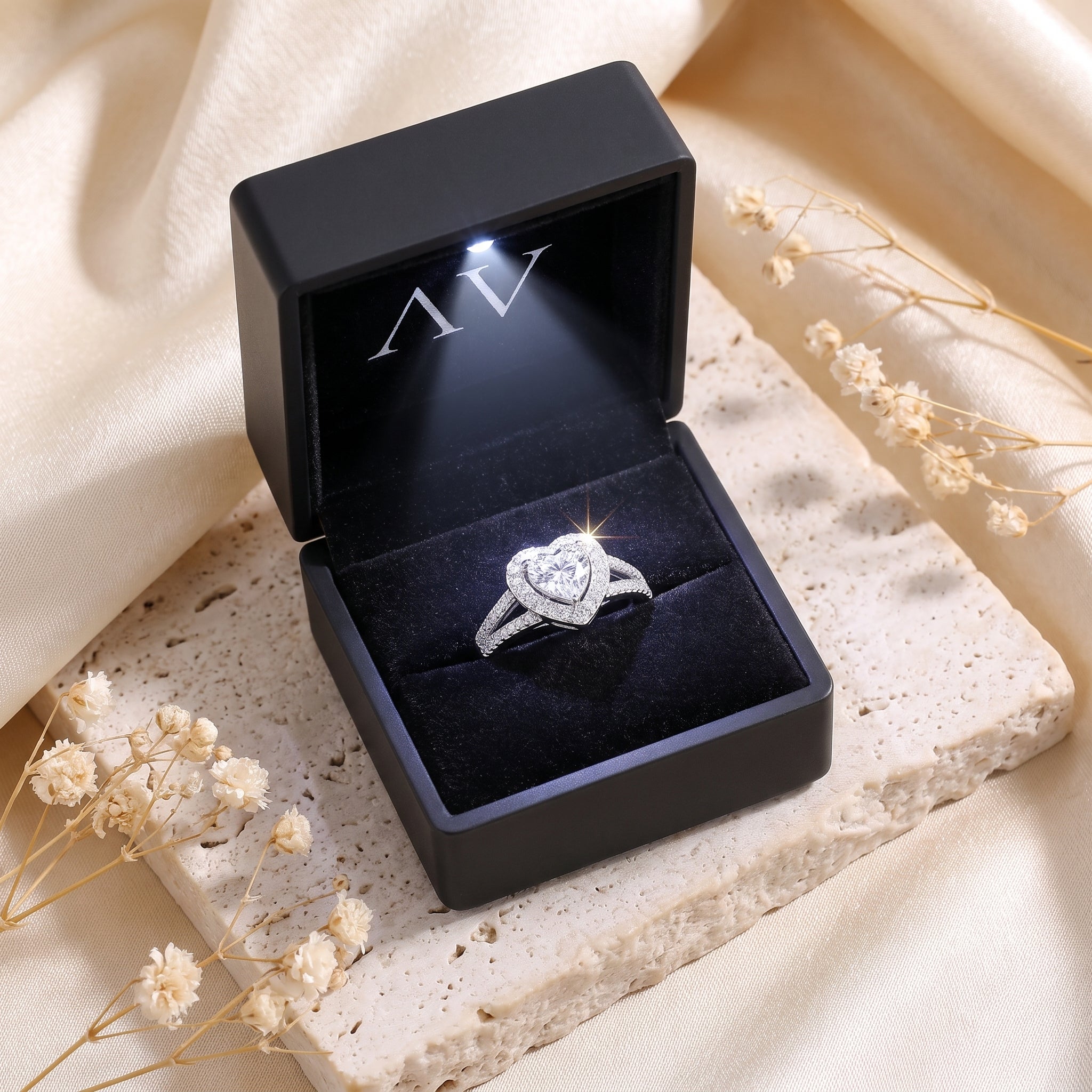 Heart-cut cubic zirconia promise ring displayed in a black LED-lit gift box.