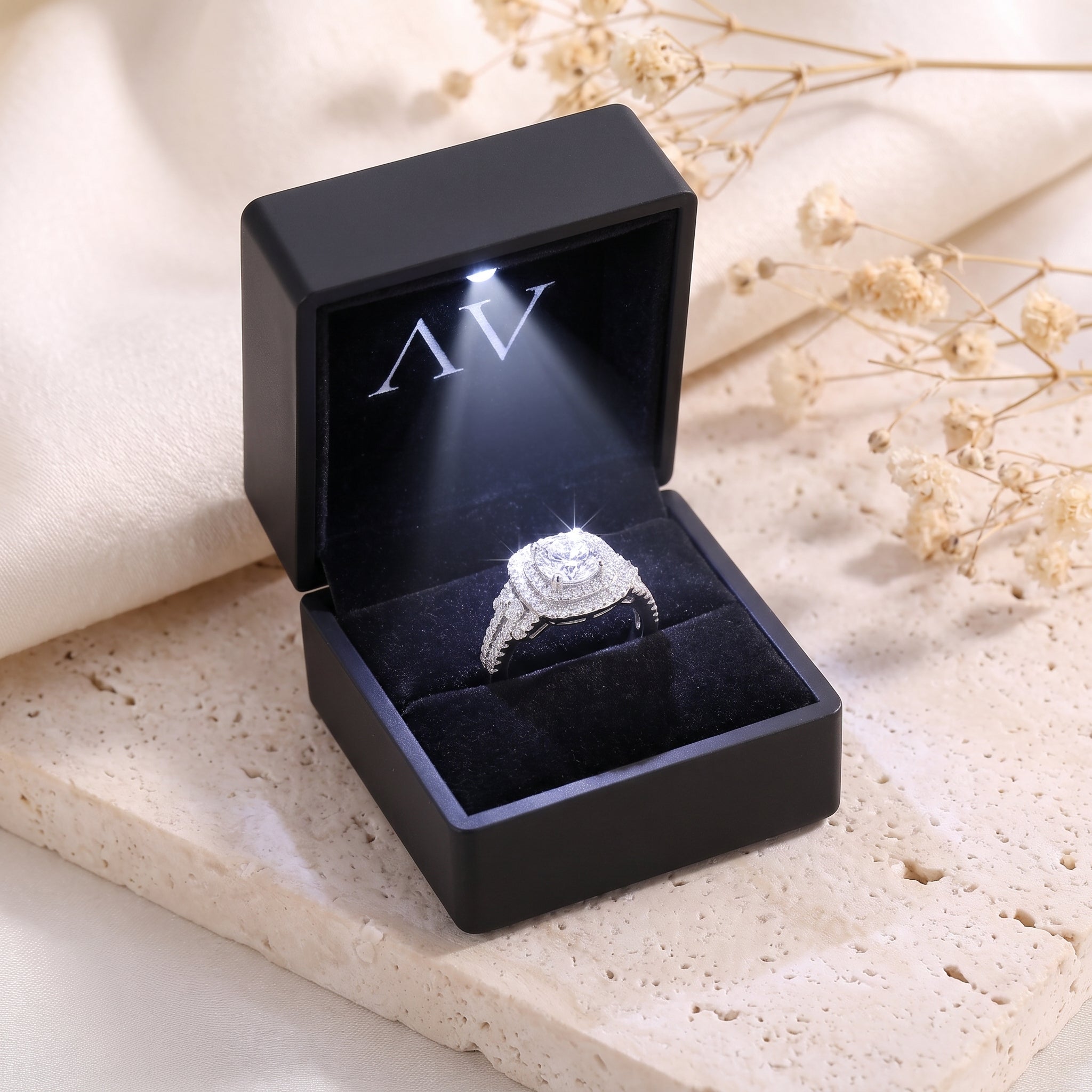 Sterling silver cushion double halo ring in a black LED-lit jewelry box.