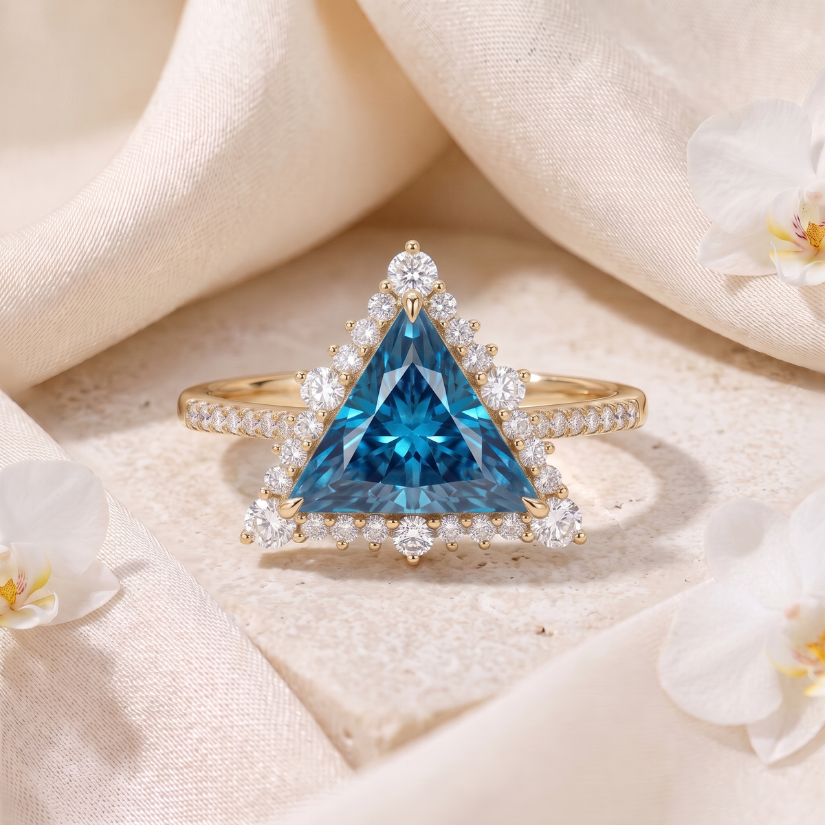 Yellow gold trillion-cut blue moissanite engagement ring with halo and pavé band