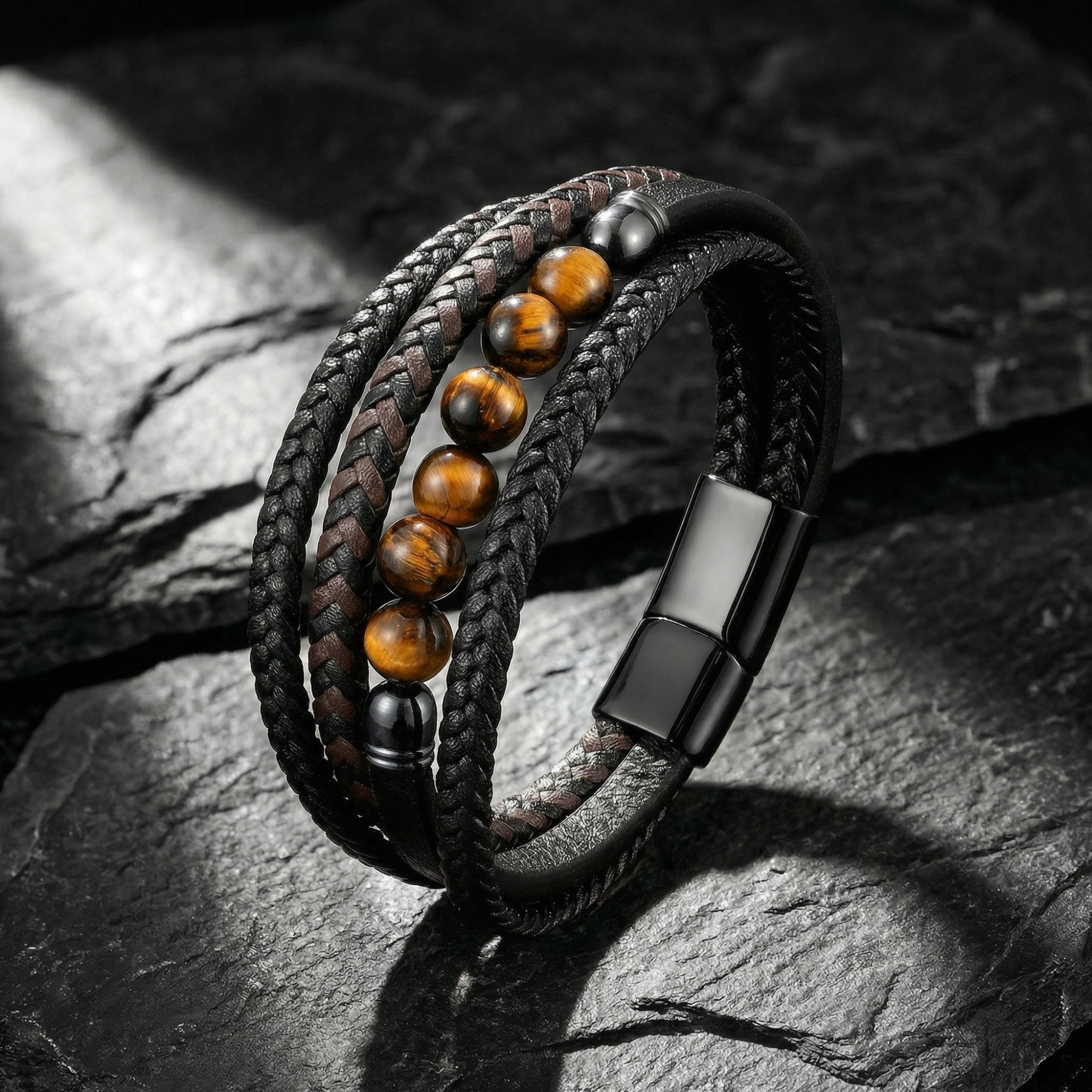 Garrison men's black braided leather bracelet with round tiger's eye beads and black stainless steel clasp on stone.