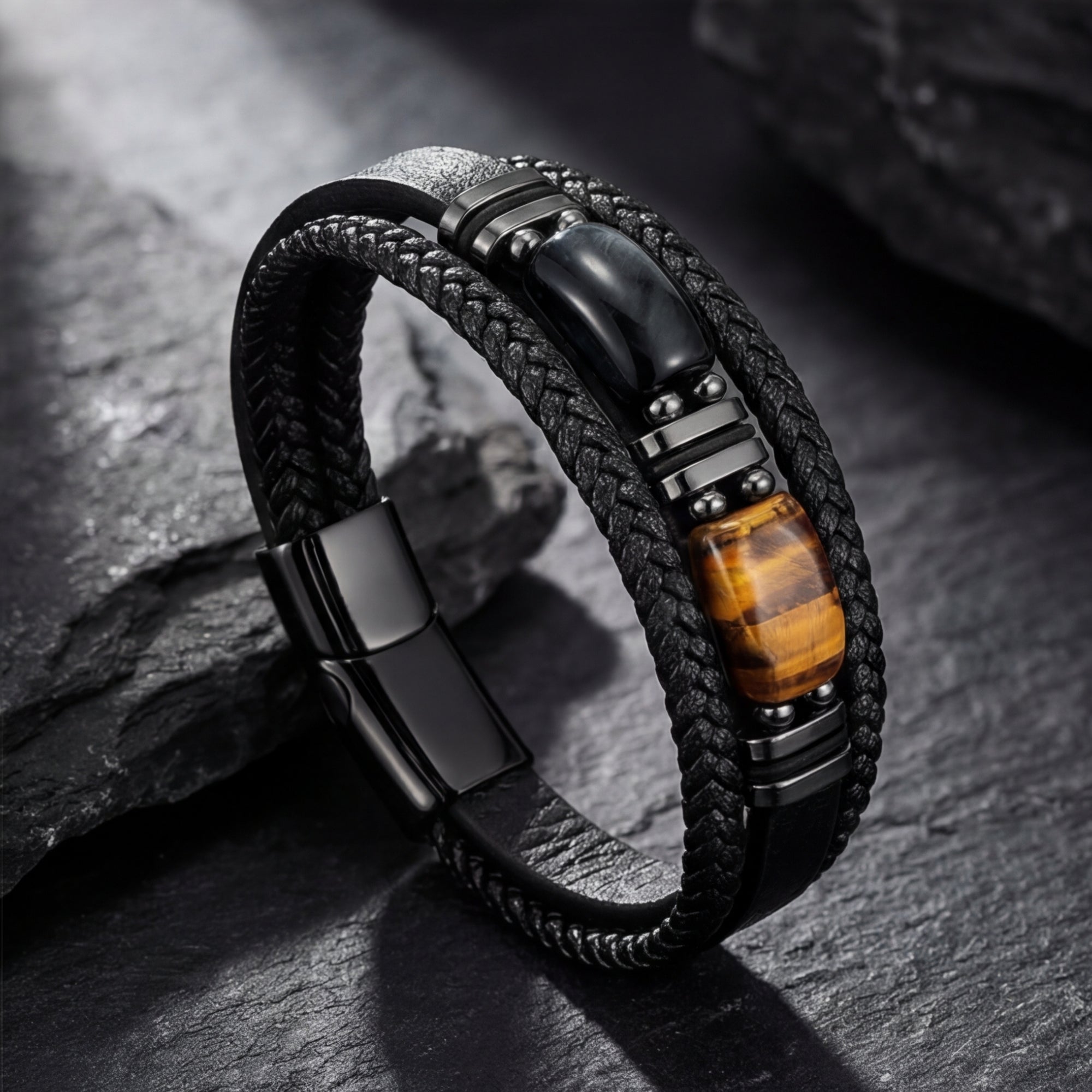 Multi-strand black leather Citadel bracelet with tiger's eye stone and black steel hardware on a dark rock.