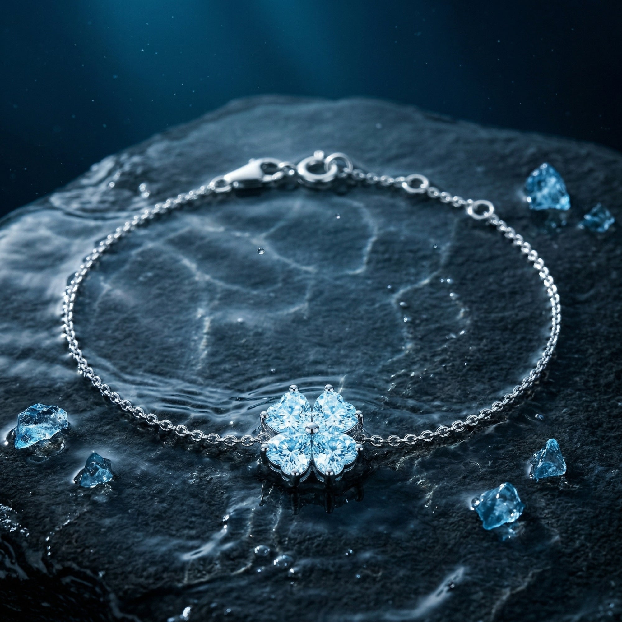 Platinum station bracelet with heart-cut aquamarines on a wet stone surface with water ripples.