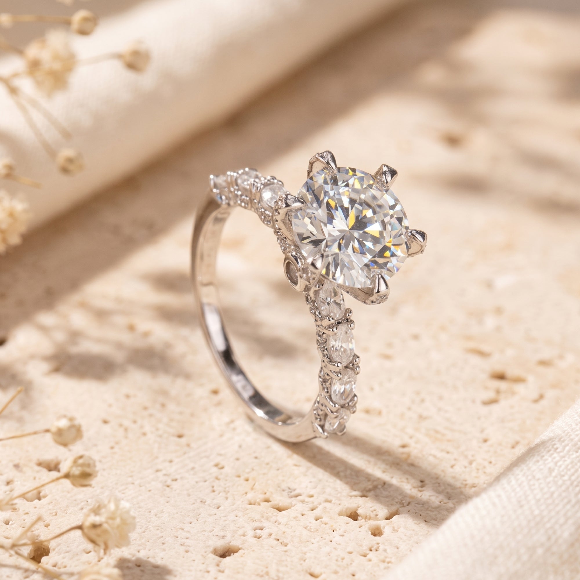 Round cut solitaire promise ring in S925 sterling silver on a textured stone surface.